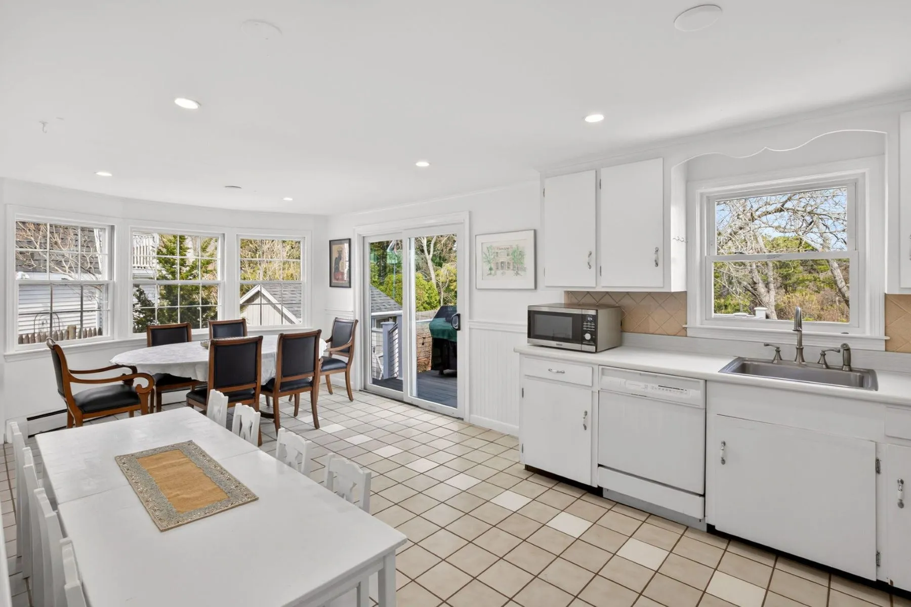 At the back of the room, a sliding glass door opens to the backyard deck extending the main living spaces toward the waterfront setting. 