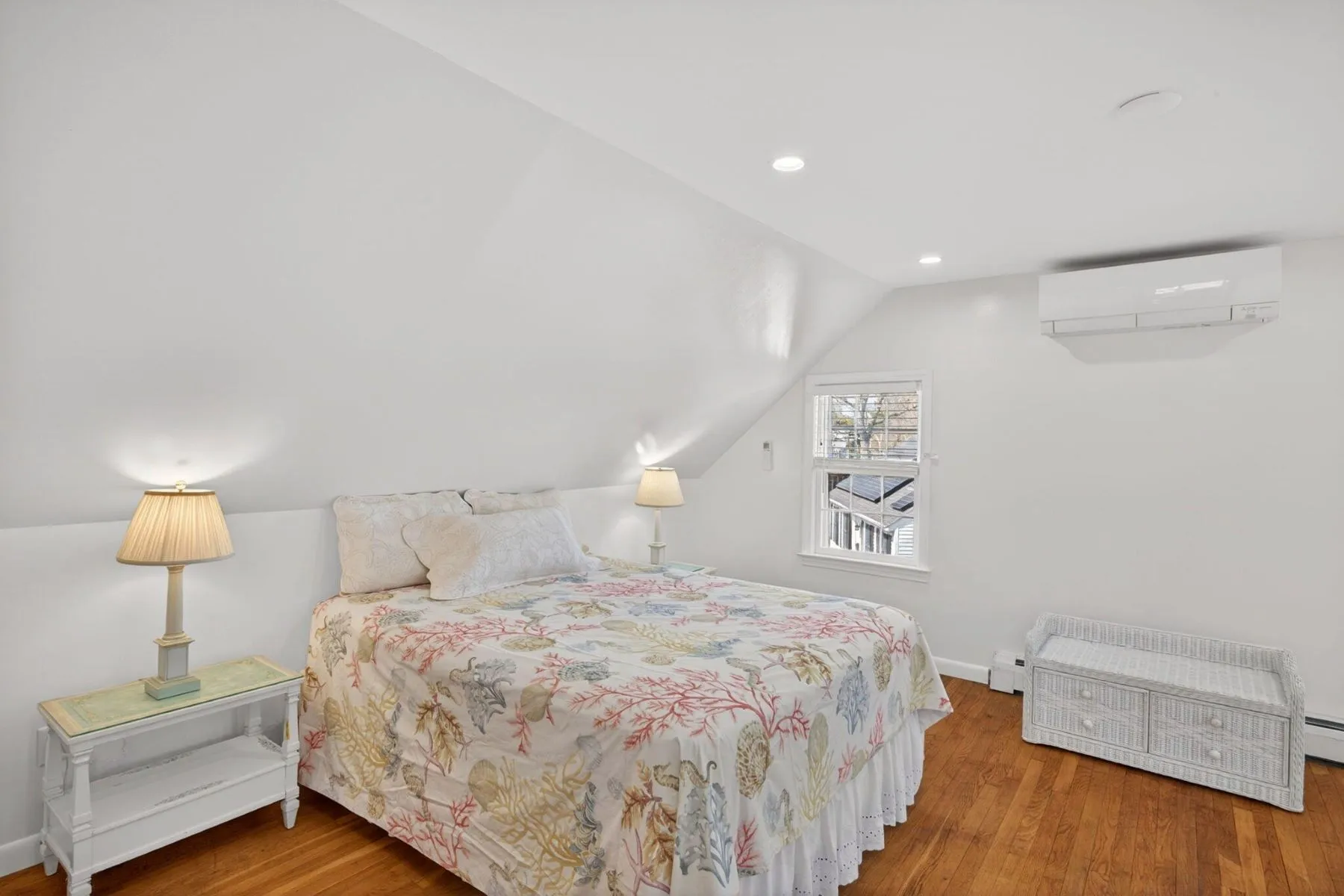 Another upstairs bedroom takes advantage of the roofline with sloped ceilings that give the room a tucked-away cottage feel. 