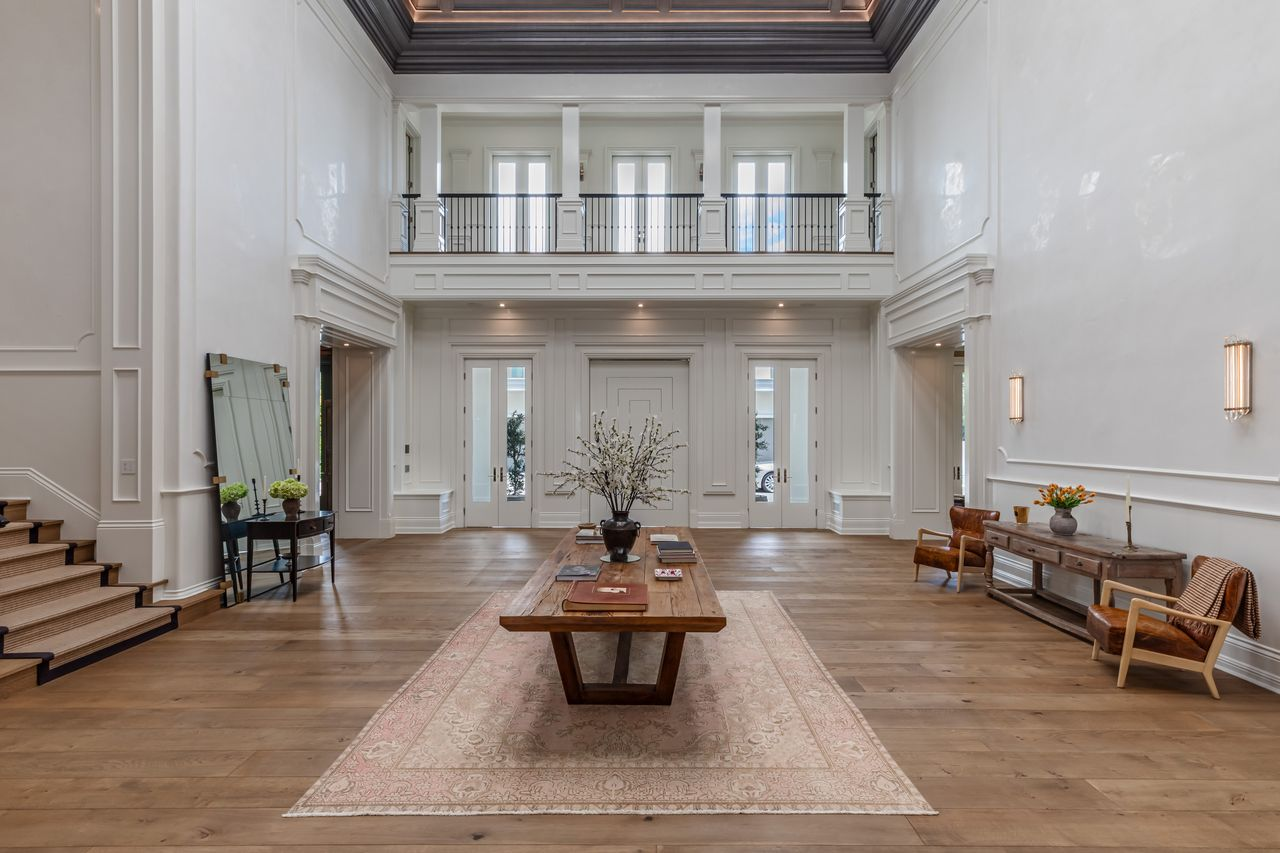 The layout opens up almost instantly from the front doors, with uninterrupted sightlines stretching across the main level toward the formal entertaining spaces and up to the second floor. 
