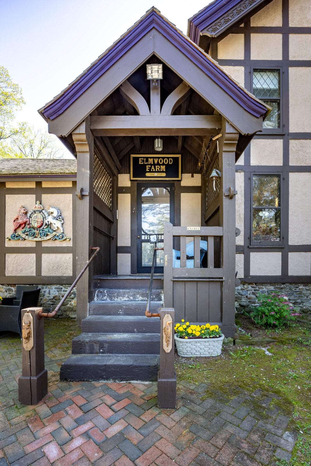 The home's architecture reflects the craftsmanship of a different era, with dramatic rooflines, carved timber details, Gothic-inspired spires, and leaded glass windows.