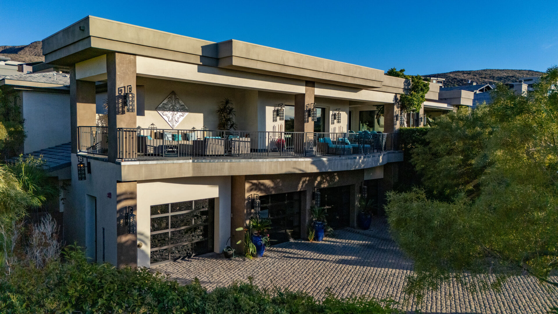 A row of garages topped by a long outdoor balcony on the second level.