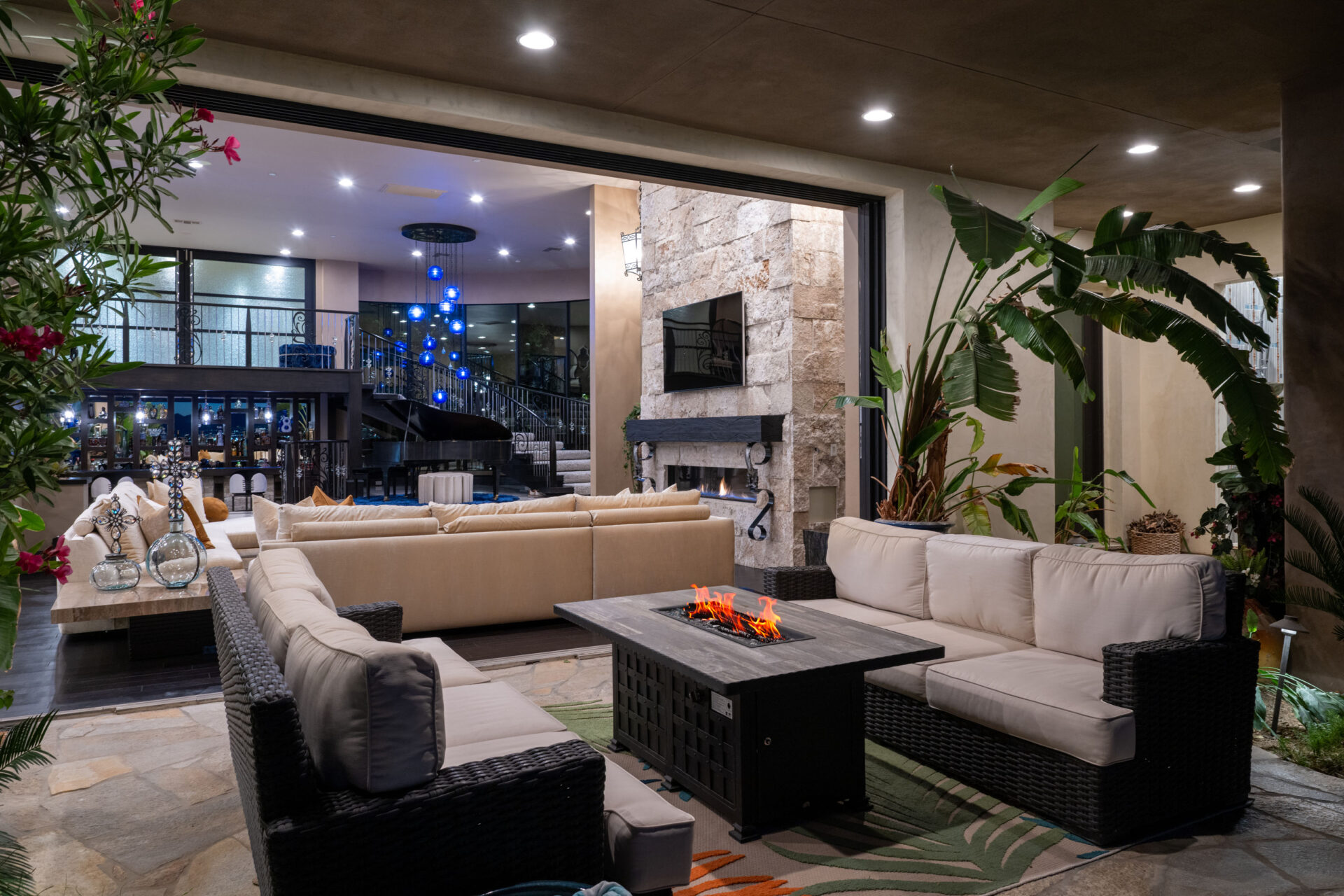 Floor-to-ceiling retractable glass walls dissolve the barrier between indoors and outdoors.