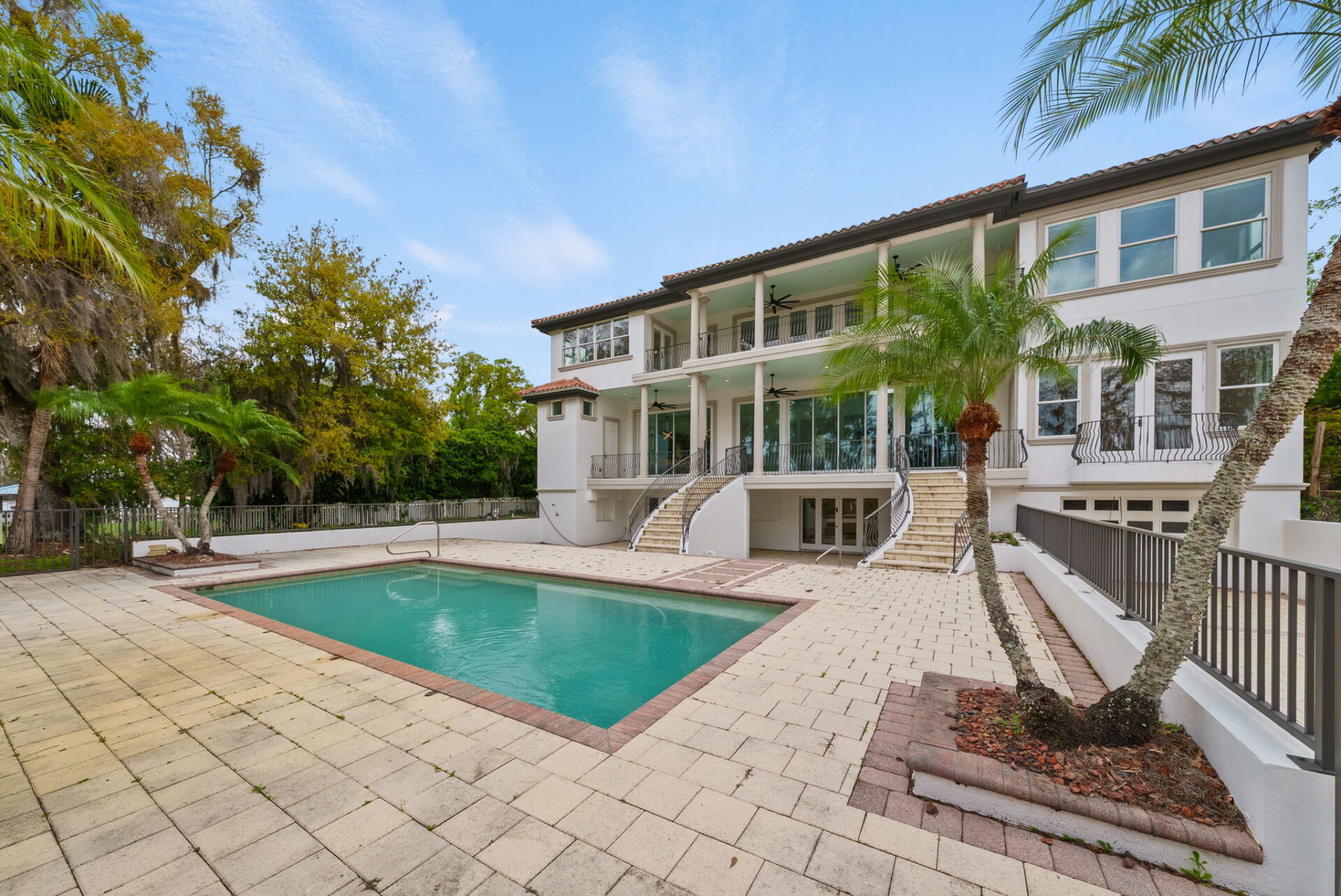 Rectangular pool surrounded by an expansive paver deck.