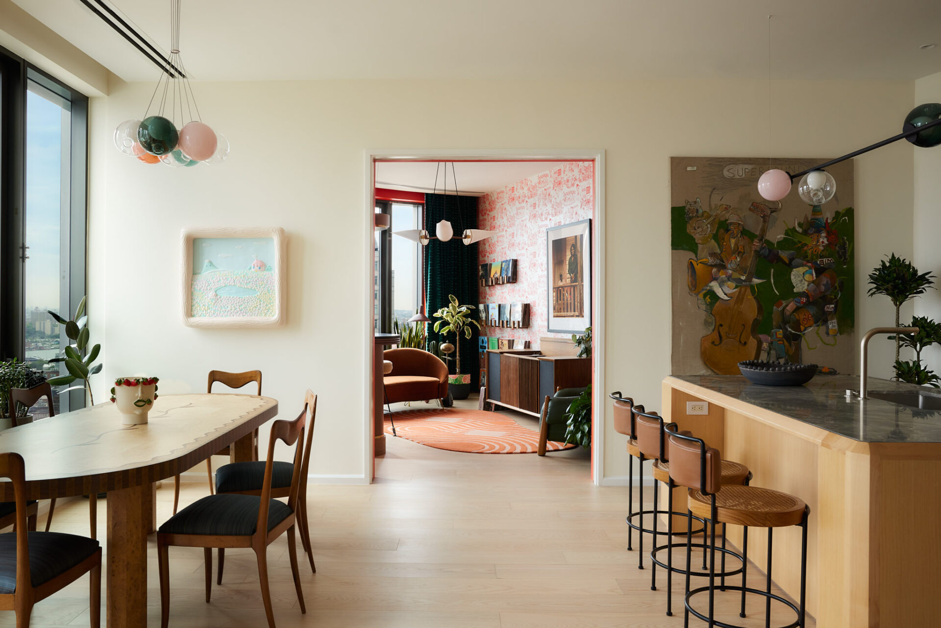 At the center of the home is a chef's kitchen built around a sculptural Fior di Bosco marble island and matching backsplash.