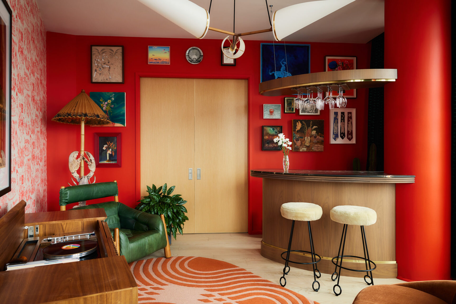 The speakeasy-inspired lounge also features a custom bar with walnut detailing, marble countertops.