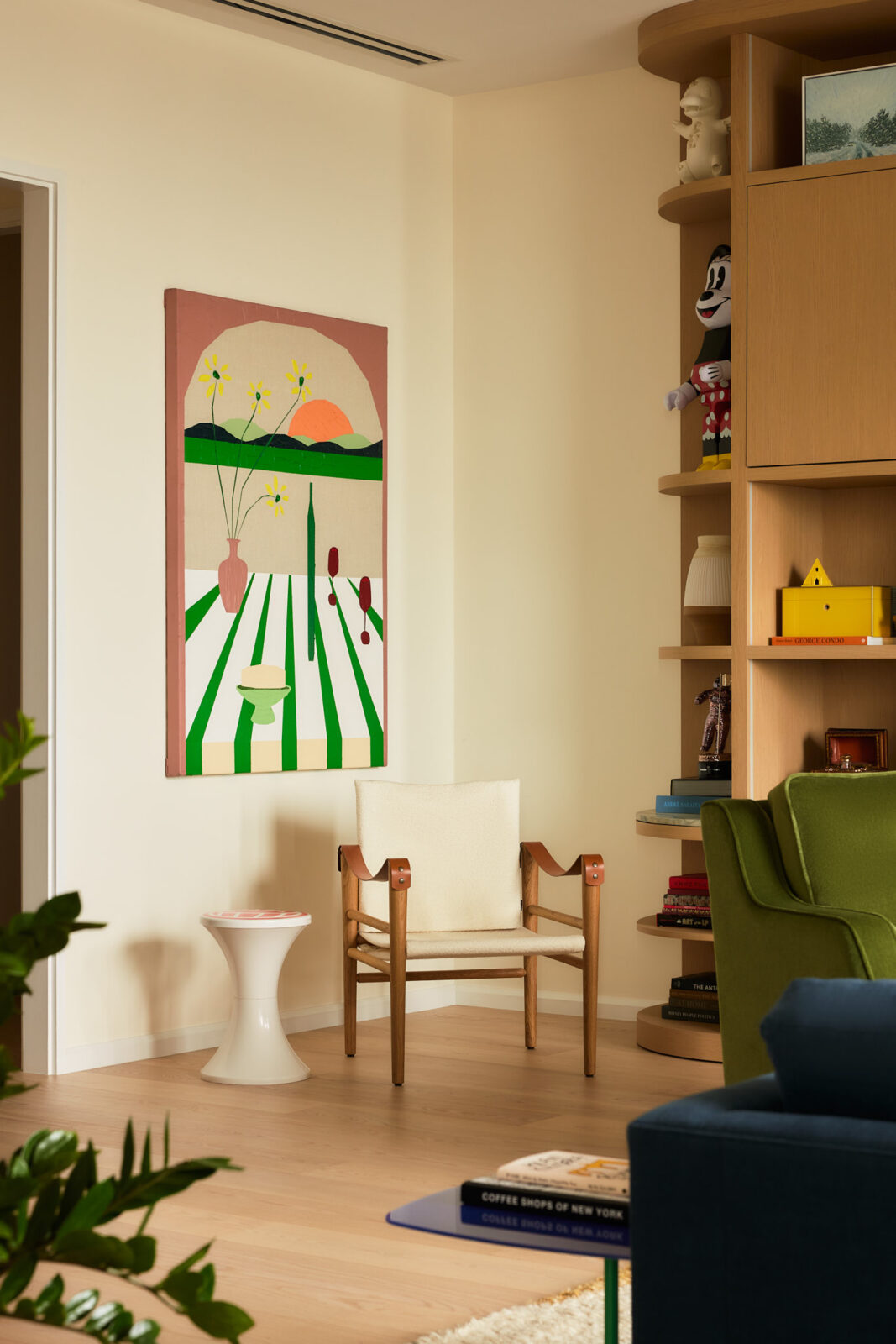 Rounded shelving, sculptural lighting, and colorful accent furnishings add personality without distracting from the views beyond the glass.