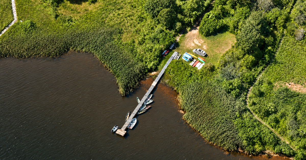 Aerial view of a private pier surrounded by boats and kayaks.