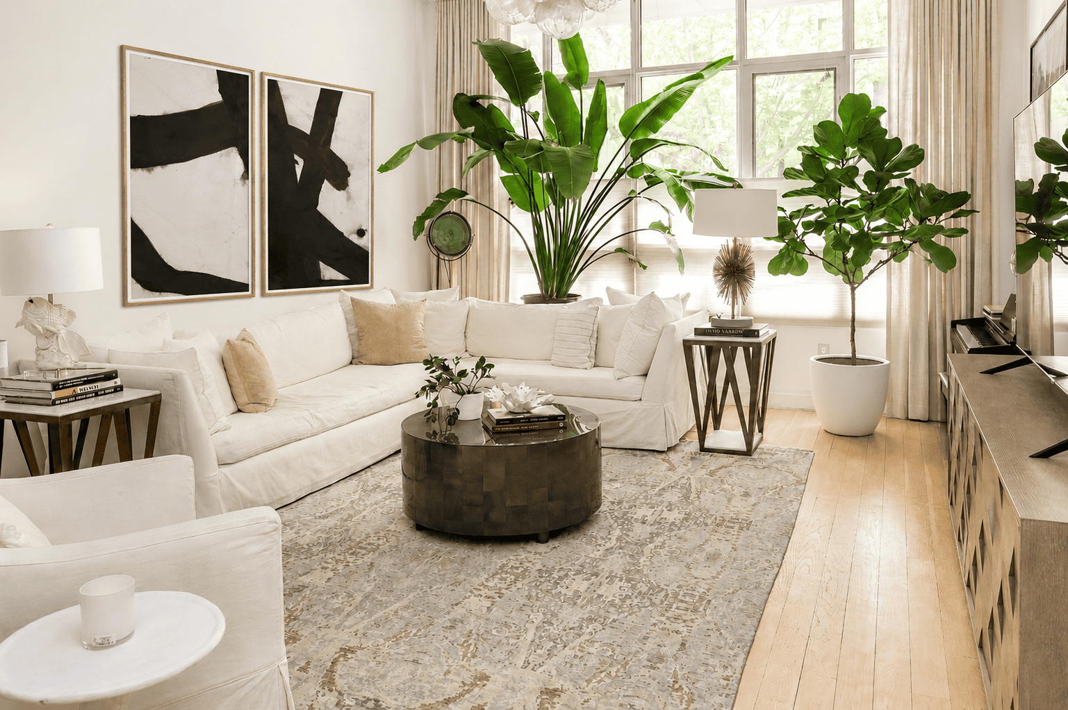 Soaring 15-foot ceilings rise above the space, while oversized south-facing windows stretch nearly floor-to-ceiling, filling the room with natural light throughout the day. 