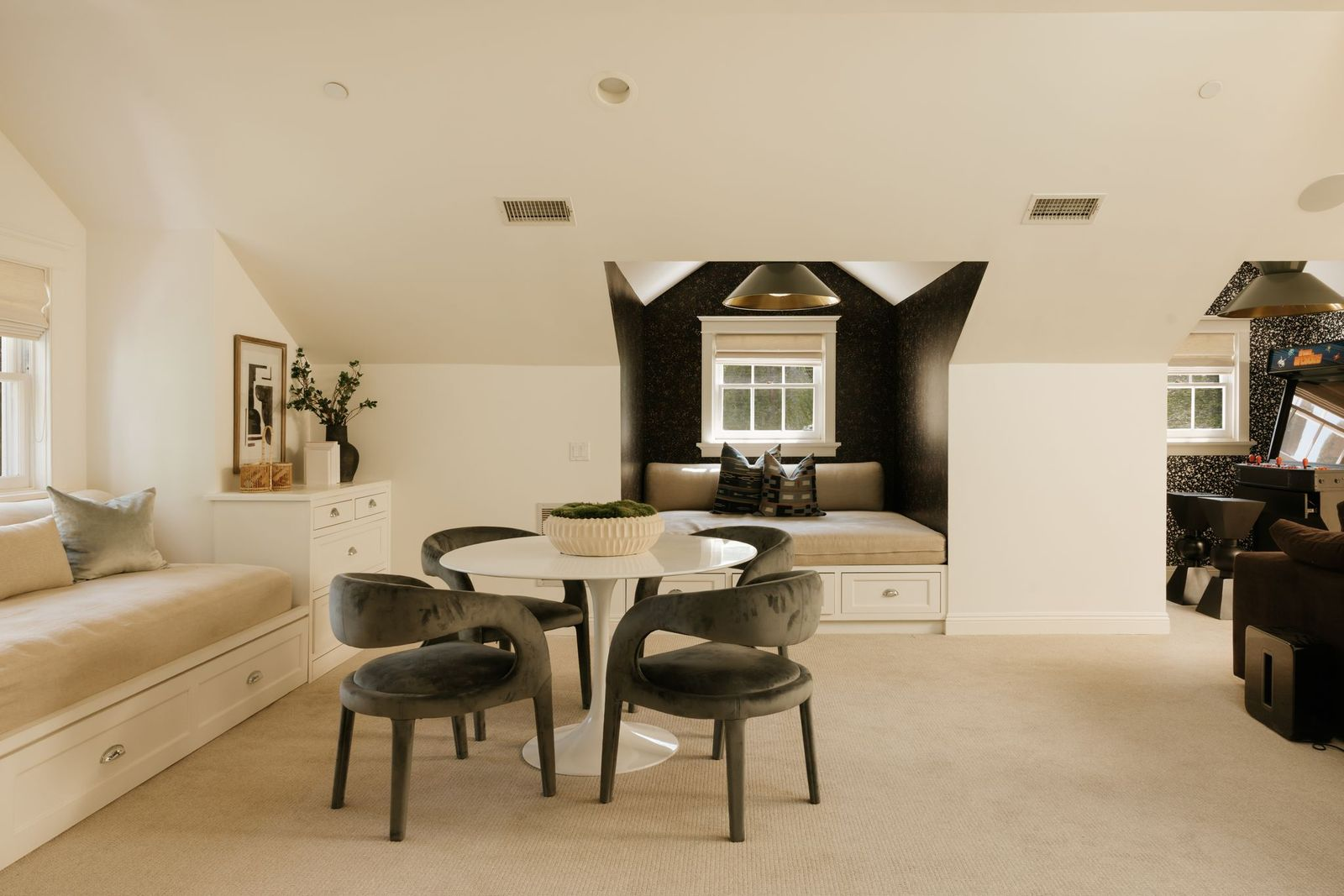 Built-in window seating, custom storage, and dedicated game and lounge areas create a space that can easily adapt to a media room, playroom, homework zone, or casual gathering space.