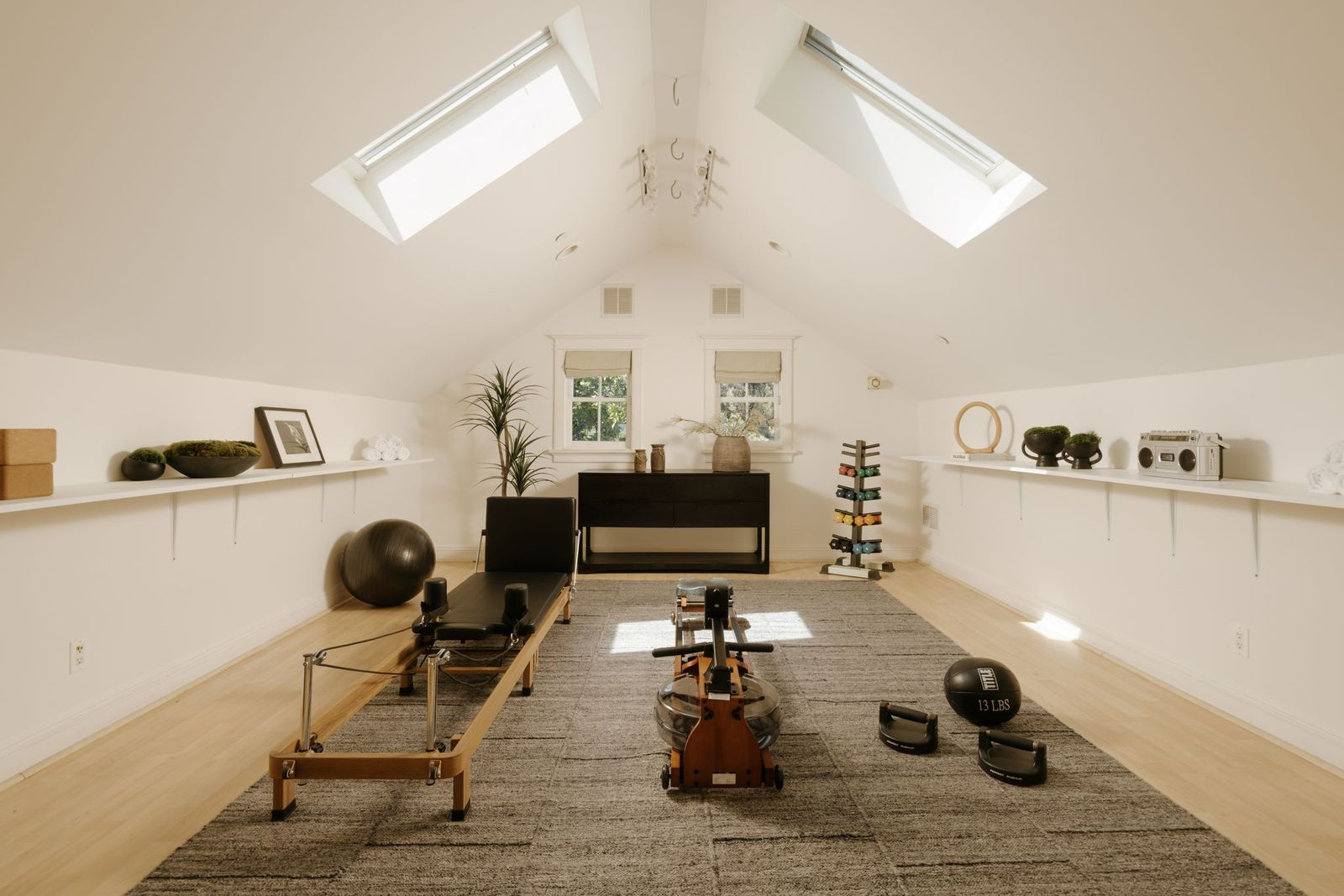 A separate fitness studio provides a dedicated area for workouts without leaving the comfort of home with plenty of space for cardio equipment, strength training, yoga, or Pilates.