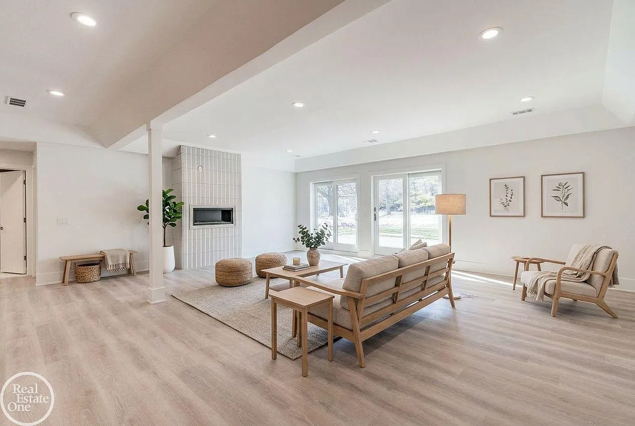 Finished in the same clean, contemporary style found throughout the rest of the home, the level begins with a spacious lounge gathered around a modern fireplace with vertically stacked tile. 