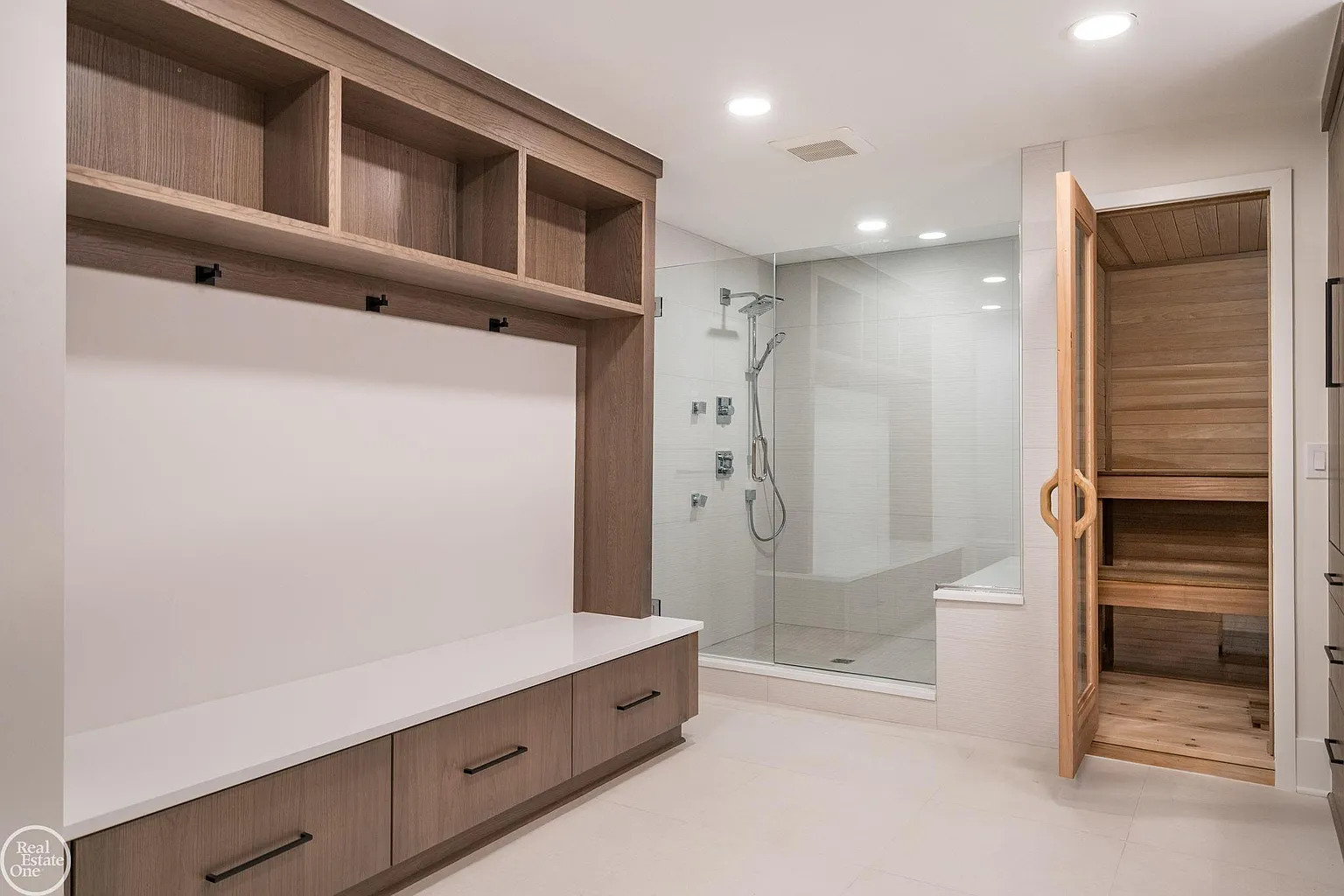 The sauna sits next to a large glass-enclosed shower.