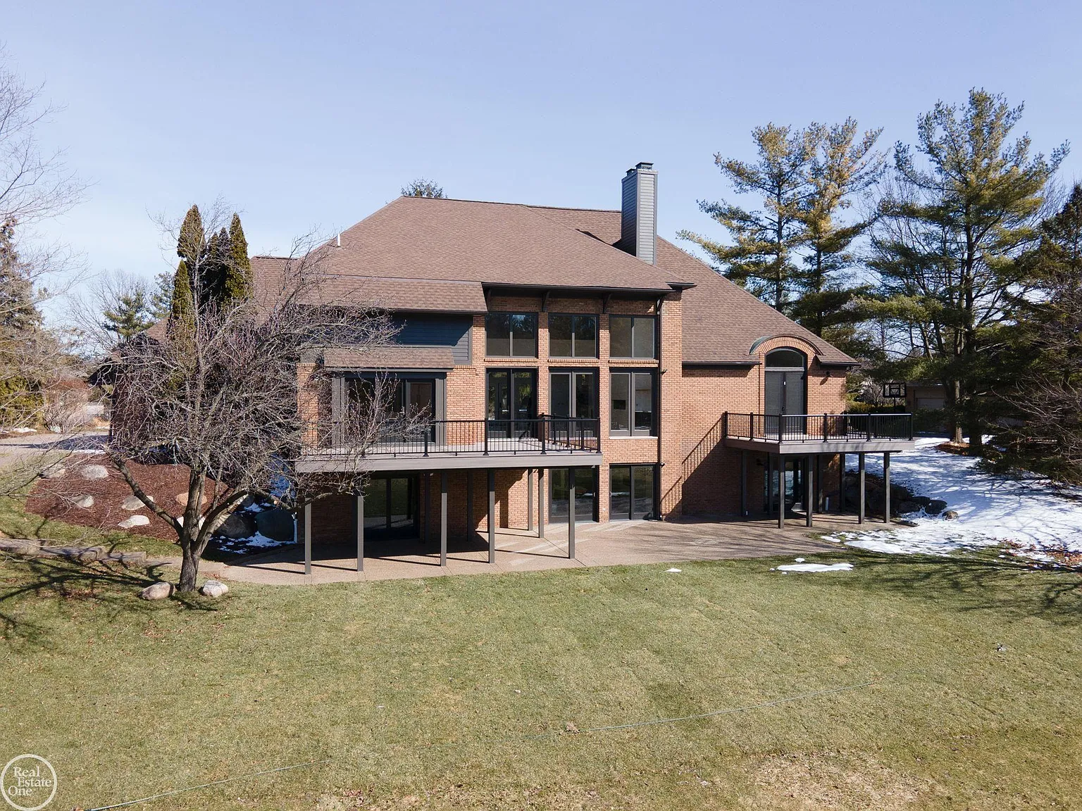 Framed by floor-to-ceiling windows and multiple access points from the main living spaces, the deck functions as an outdoor extension of the home's interior.