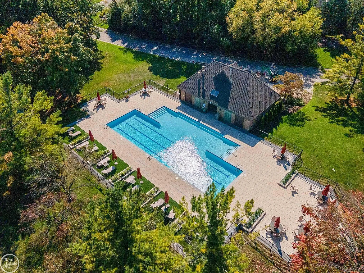 Surrounded by an expansive sun deck with multiple seating areas, the pool is complemented by a dedicated pool house and generous space for lounging, entertaining, and hosting larger gatherings.