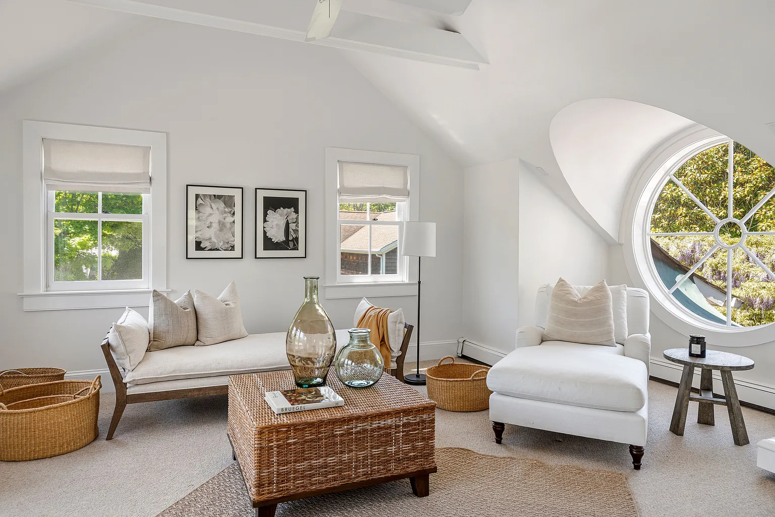A sitting room with a distinctive round window.