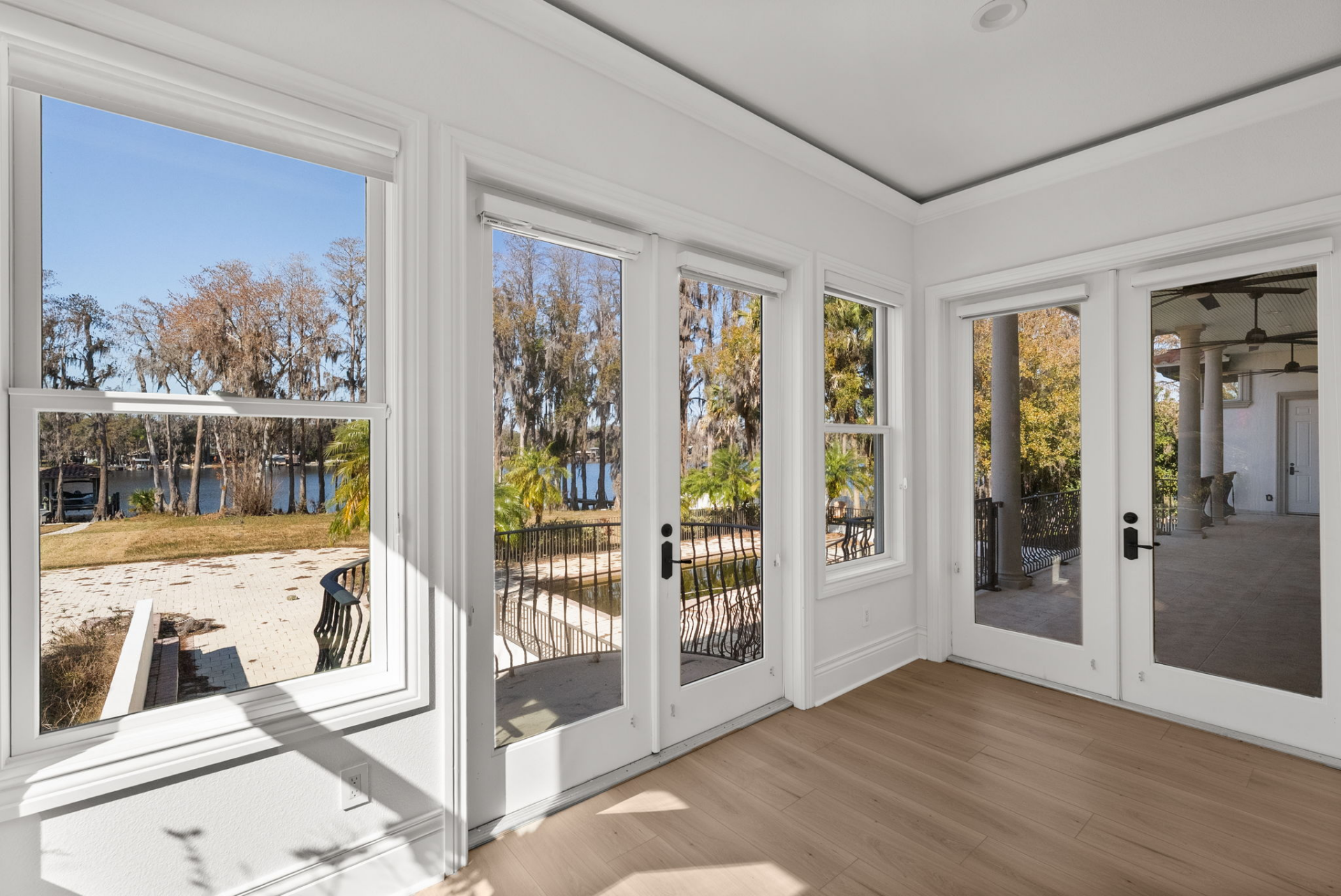 Bedroom doors leading to a private balcony and shared balcony space.