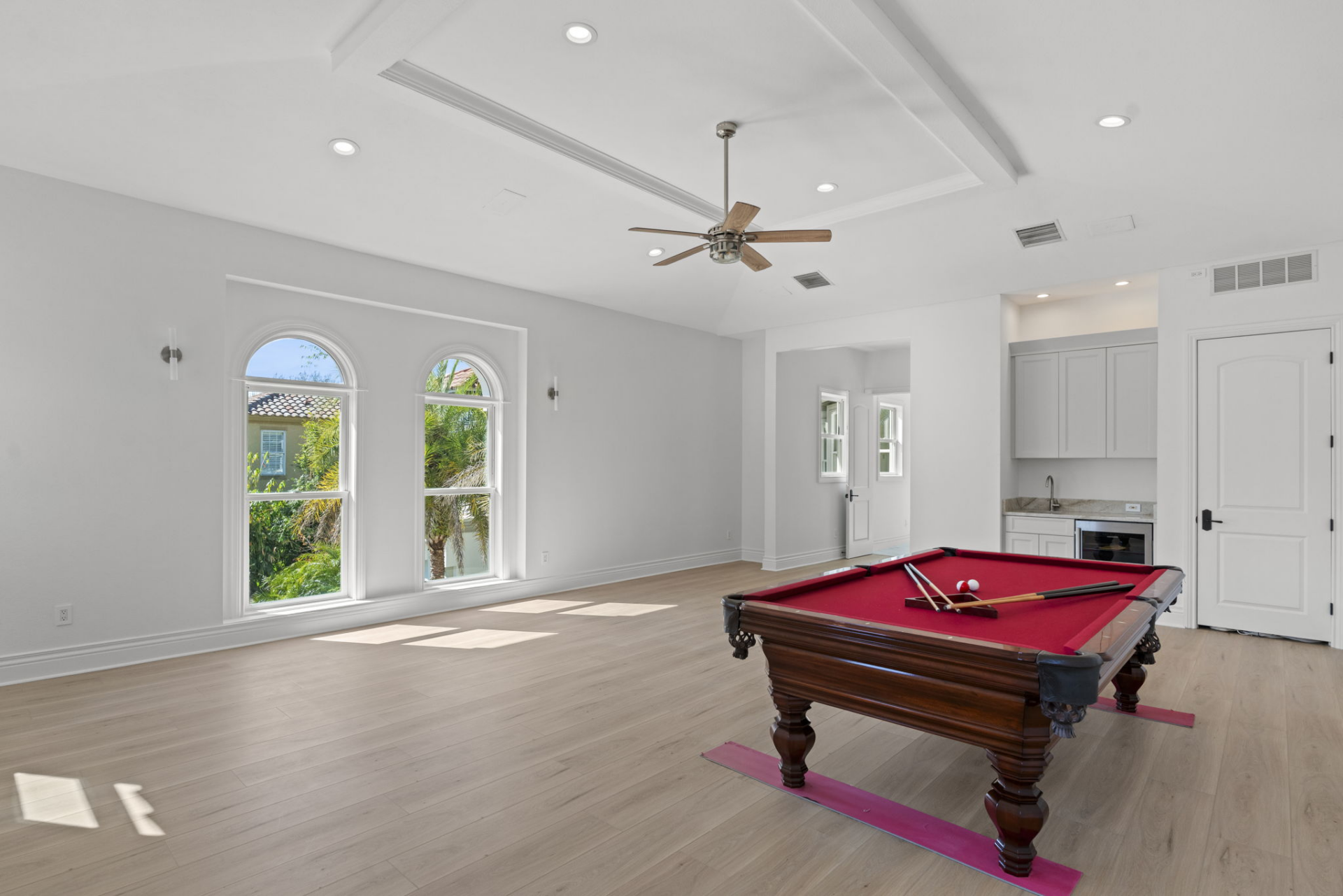 A large upstairs entertainment room, which comes with a wet bar, provides space to create a game lounge, media setup, or gathering area.