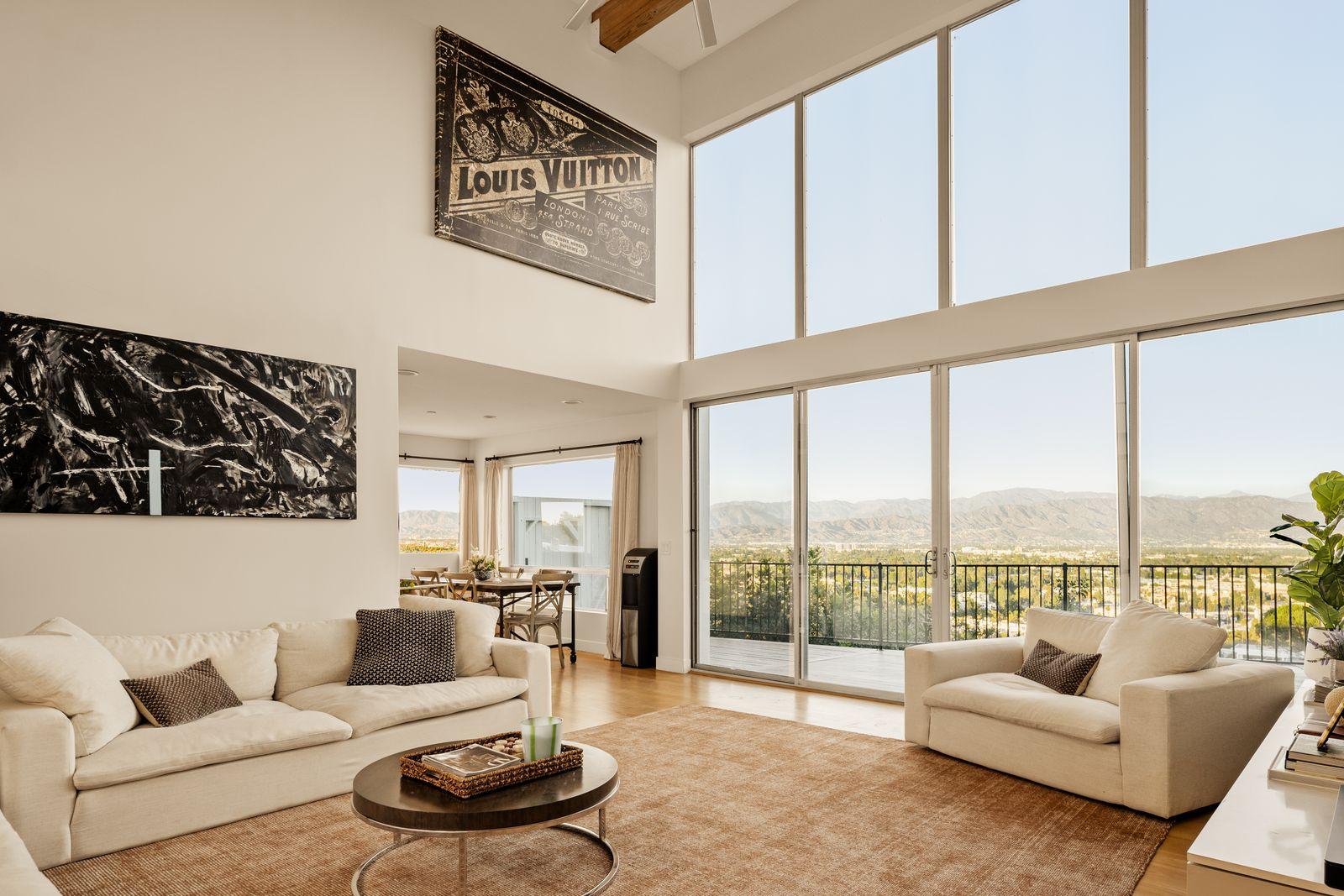 Expansive walls of glass stretch across the rear of the space, drawing in natural light throughout the day.