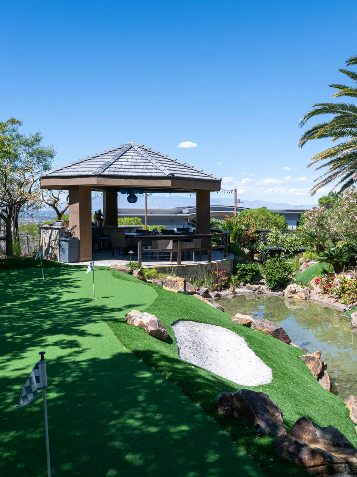 A private putting green winds alongside a stream.