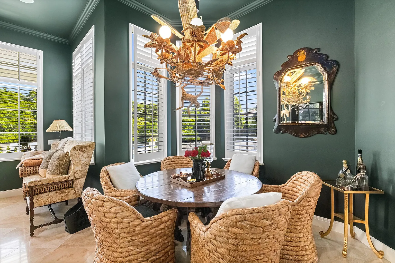 Off to the side, a sunlit breakfast nook is tucked into a bay of windows.