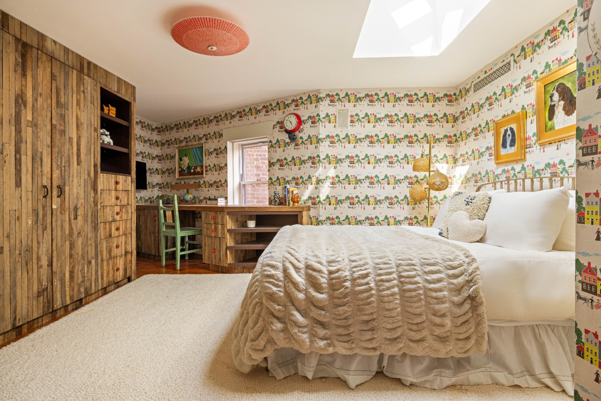 As one of the most playful guest rooms in the penthouse, this bedroom is lined with wallpaper depicting rows of colorful houses.
