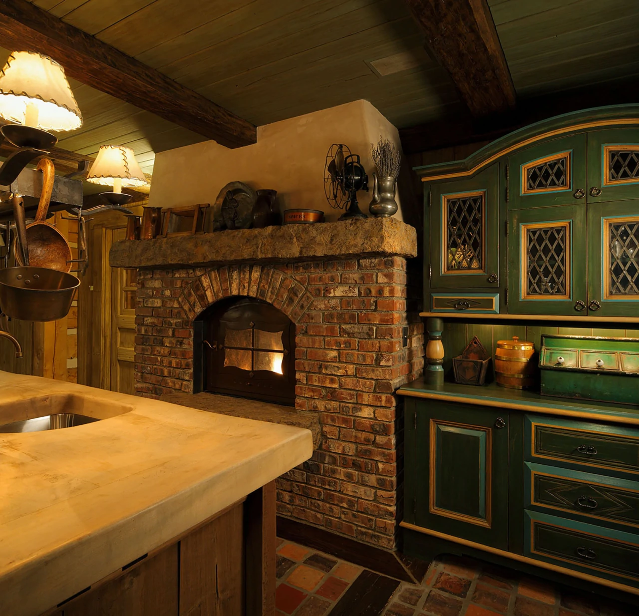A substantial brick fireplace anchors the room, while hand-finished cabinetry, timber beams, stone countertops, and copper pots reinforce the cozy cabin design.