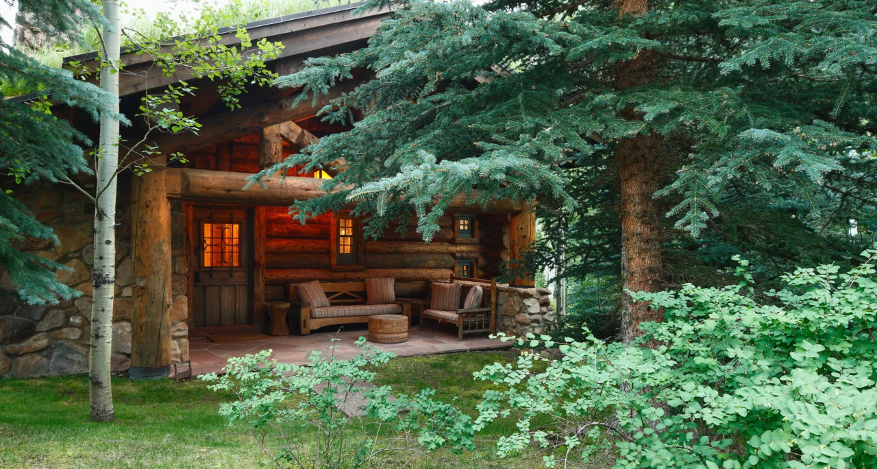 This covered porch is among the most inviting, framed by mature evergreens.