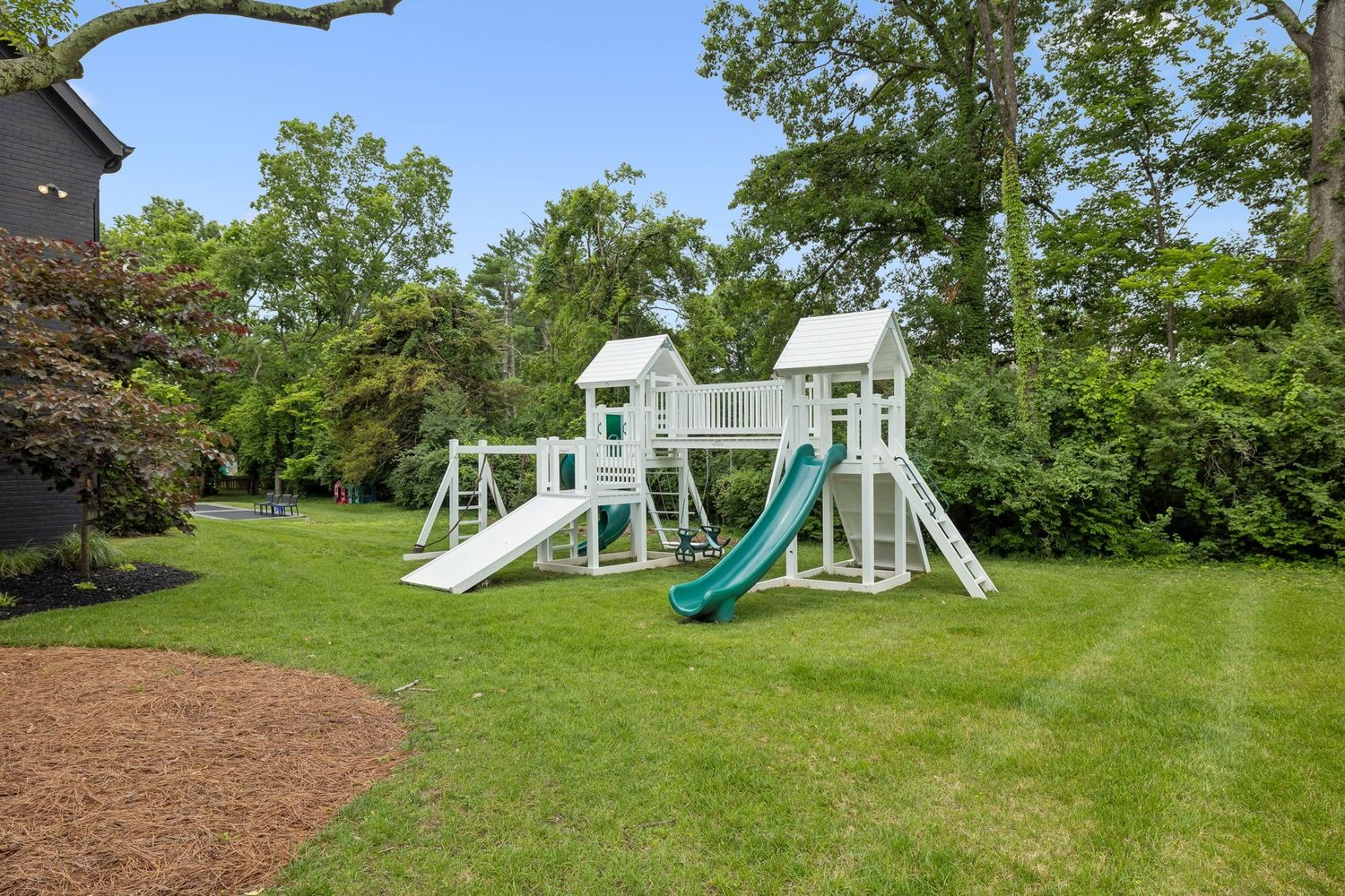 The first is a large custom playground featuring slides, swings, and climbing elements. 