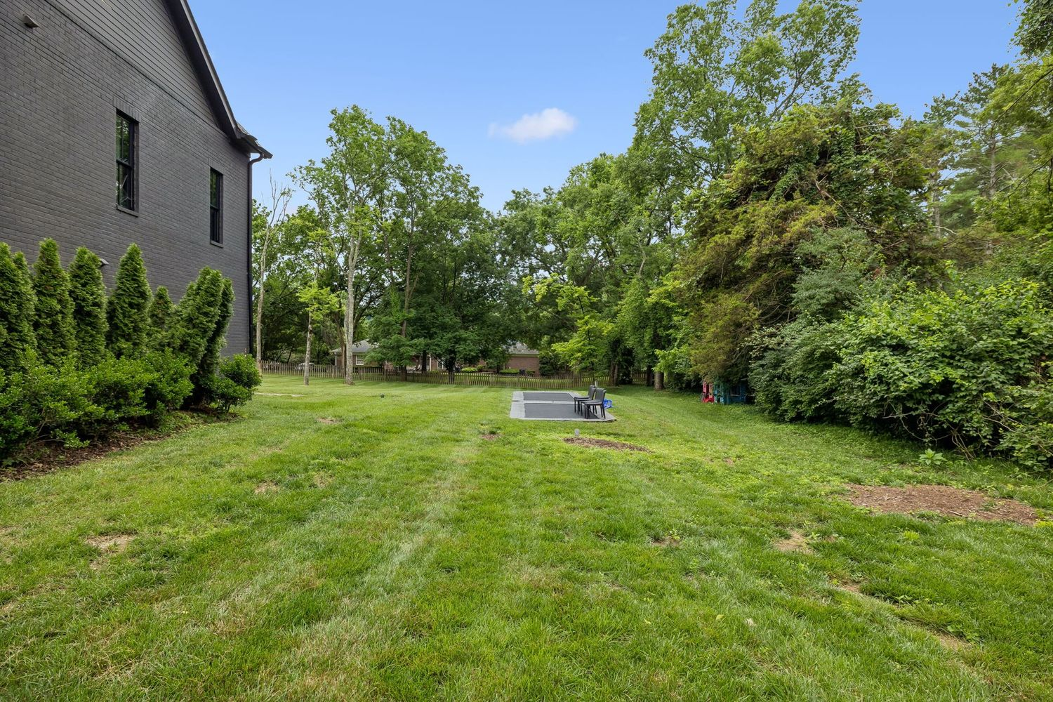 Past the slides, you'll also find two in-ground trampolines placed within the large stretch of lawn.