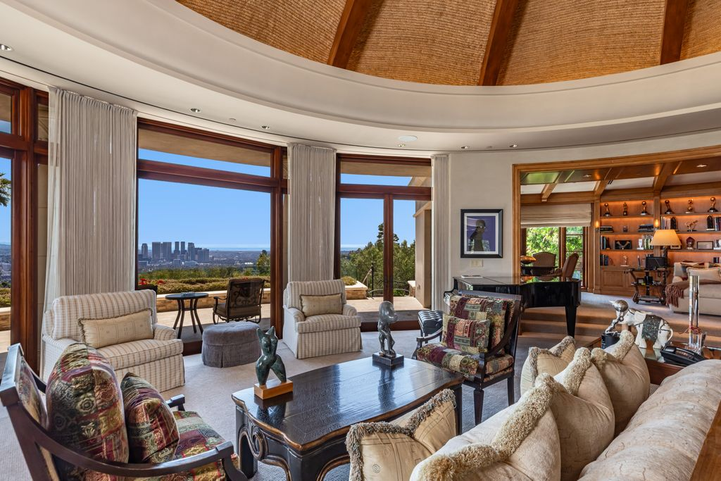 The home's main gathering space is a circular great room positioned to capture views across Bel Air toward the Los Angeles skyline.