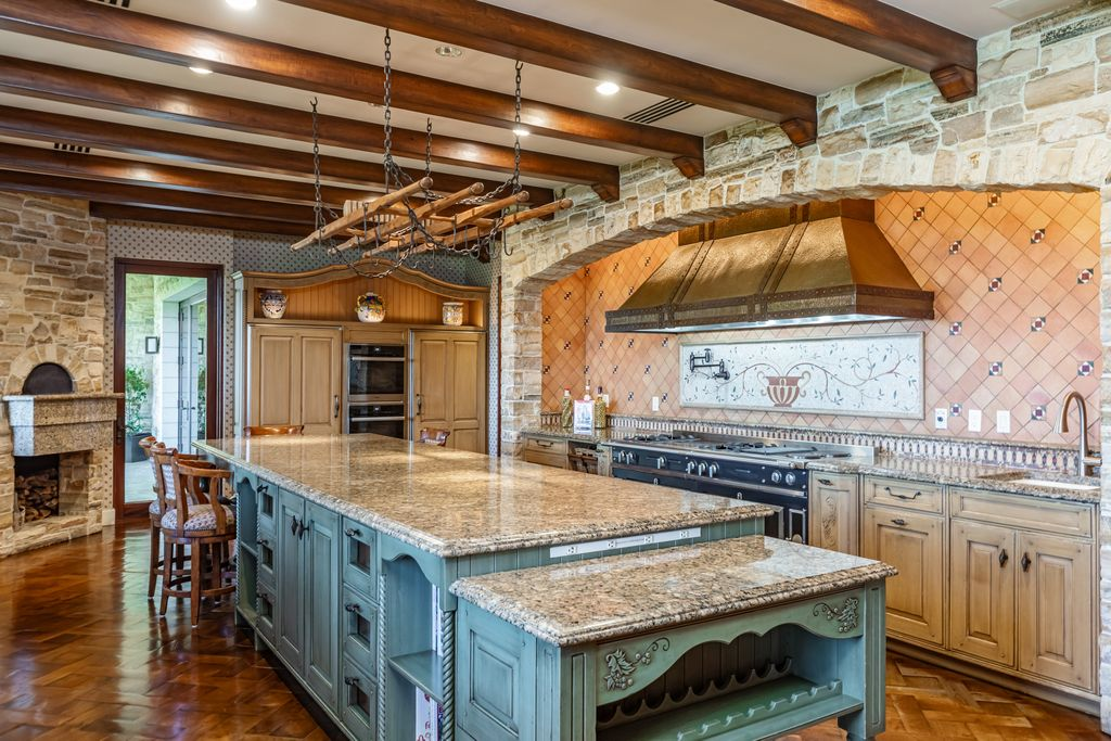 The kitchen shifts toward a more rustic European design, with stone walls, exposed wood ceiling beams, and detailed cabinetry.