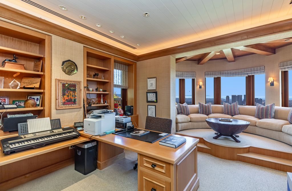 The estate also includes an executive office with custom-built cabinetry and a central desk set up for both music production and desk work.