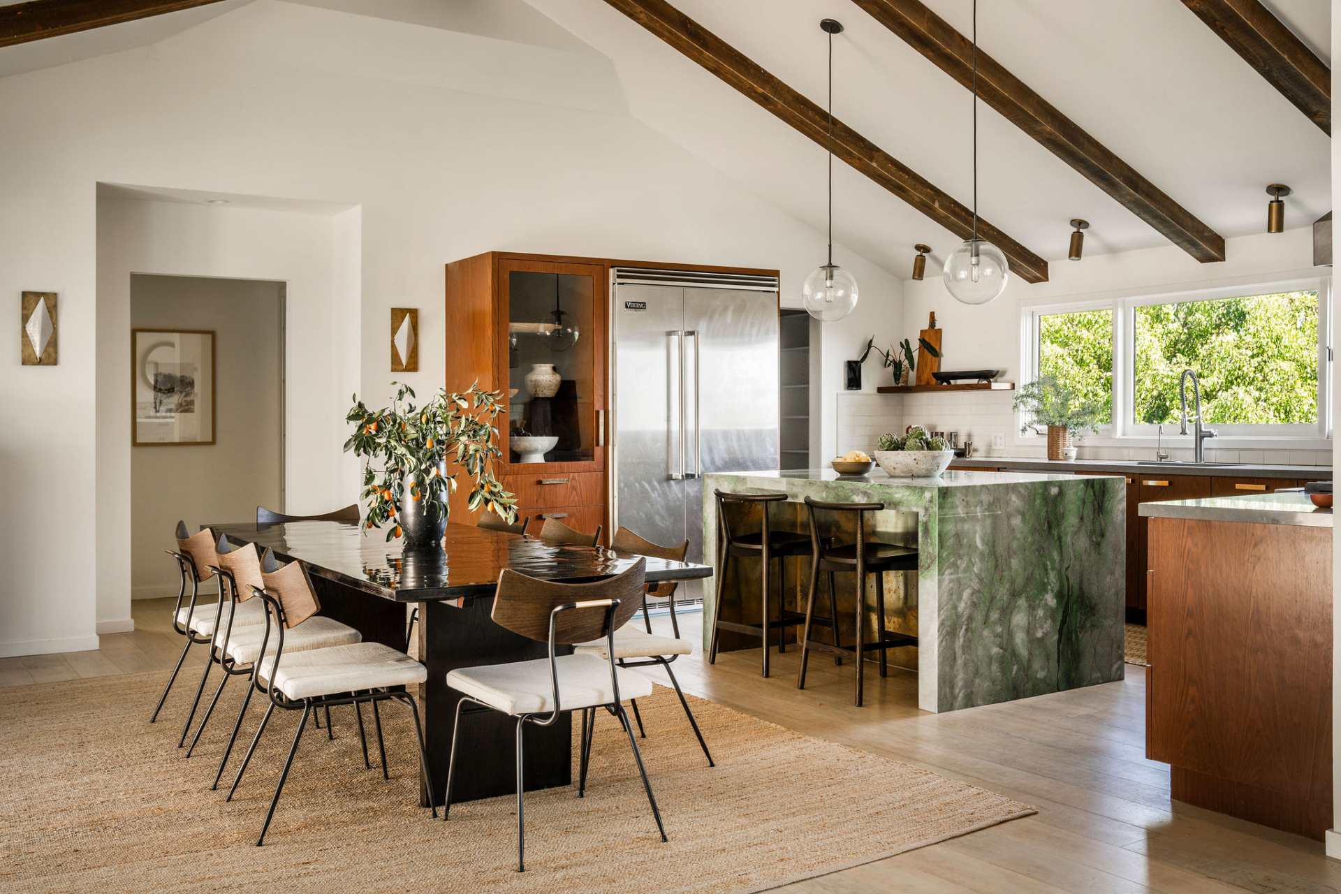 Next to the dining area, the kitchen continues the home's open layout while introducing a richer mix of materials and textures.