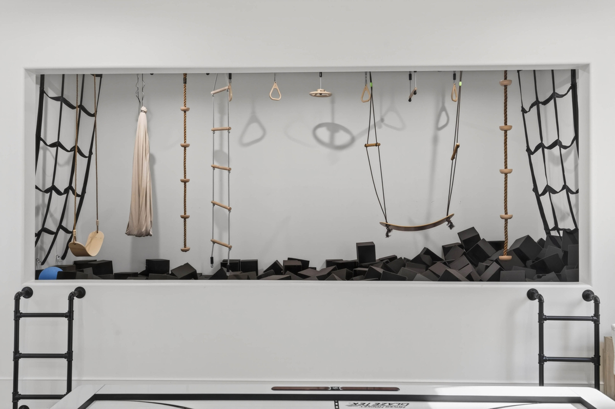 One of the most unique amenities is a private indoor gymnasium featuring a foam pit, climbing elements, rope obstacles, gymnastic rings, and other training features.