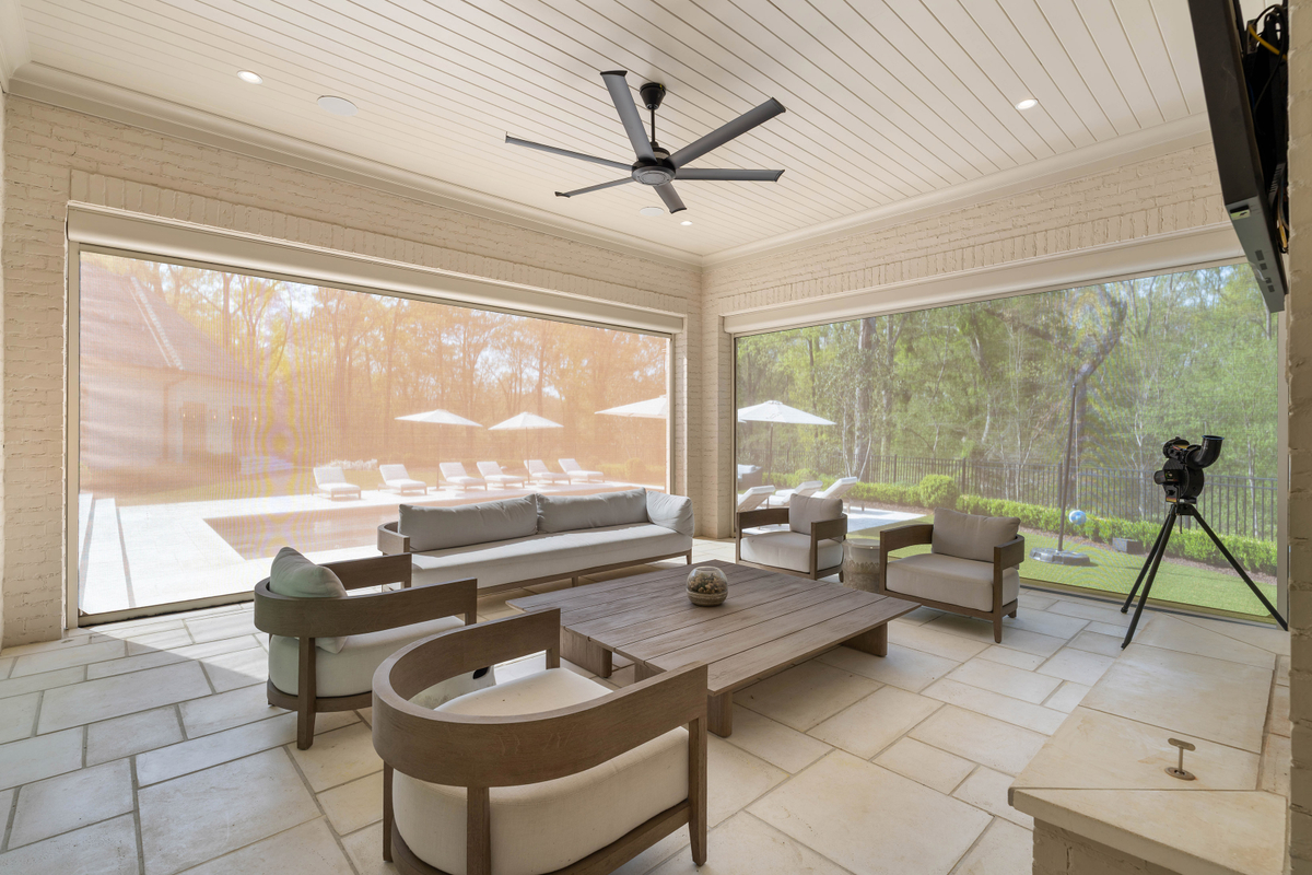 A tongue-and-groove ceiling, fireplace, and lounge seating create a comfortable setting for year-round use, in addition to the automated Phantom screens, which can be lowered as needed.