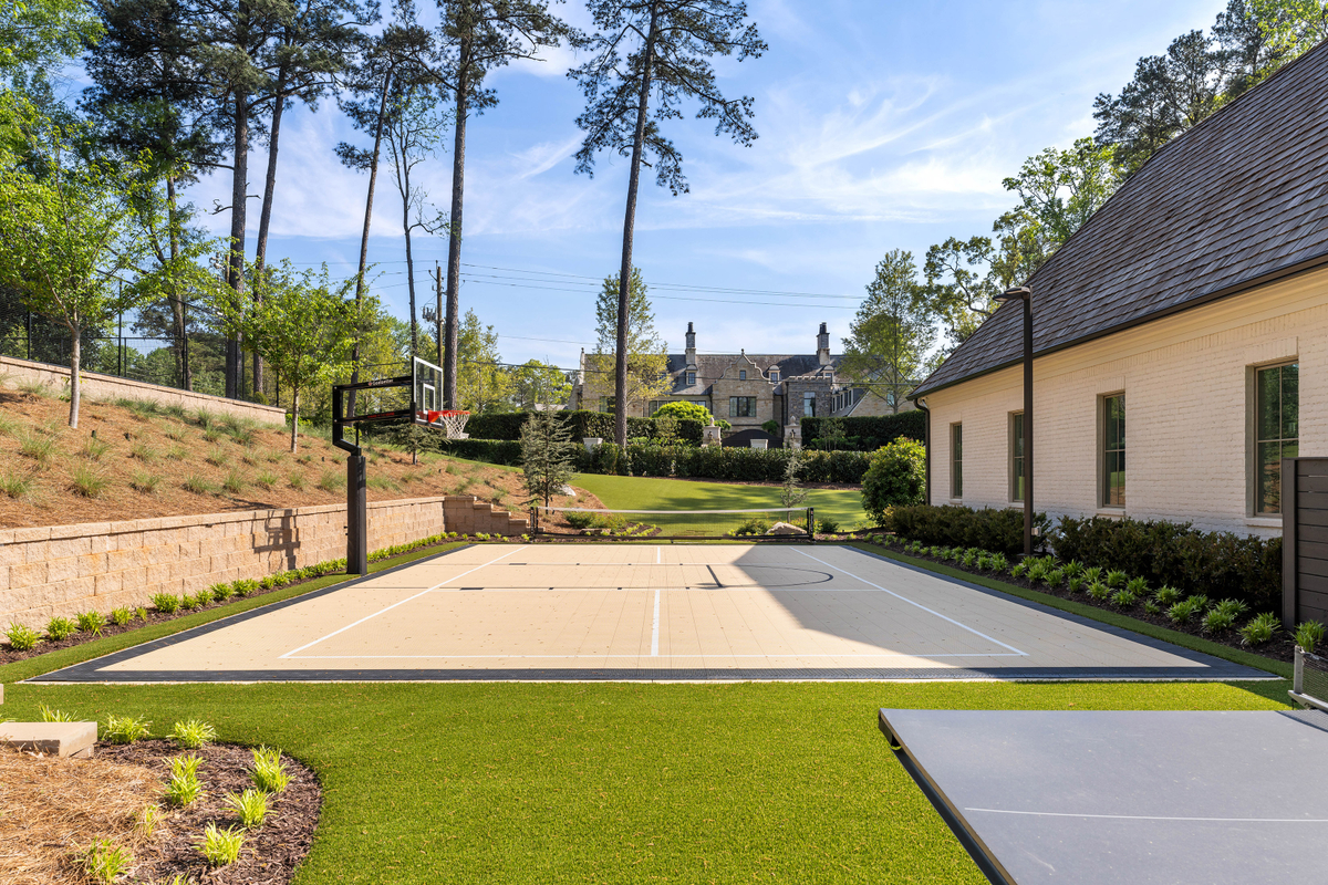 Just a few steps away is the sports court configured for both pickleball and basketball.