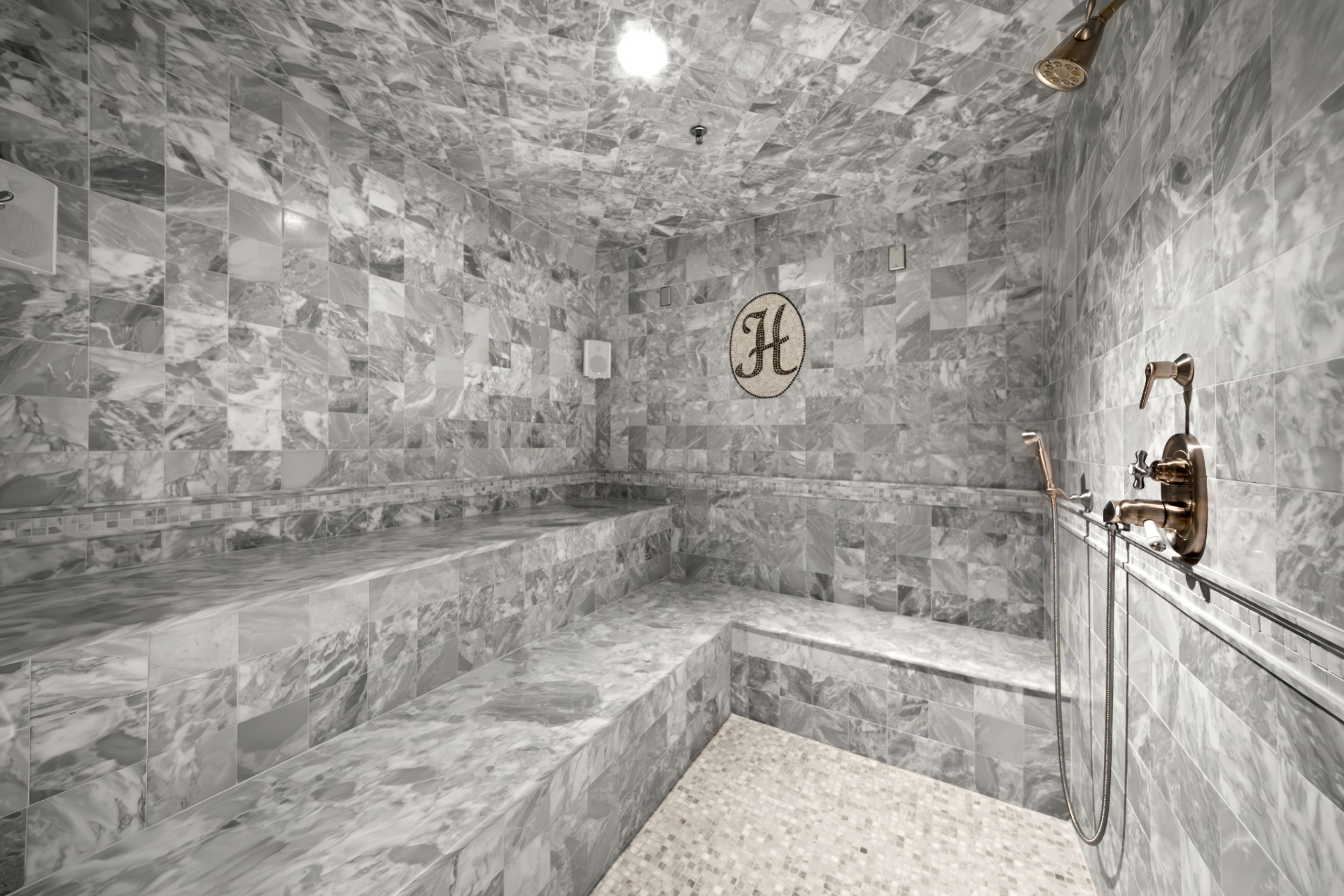 Complementing the fitness facilities is a fully tiled steam room finished in gray marble.