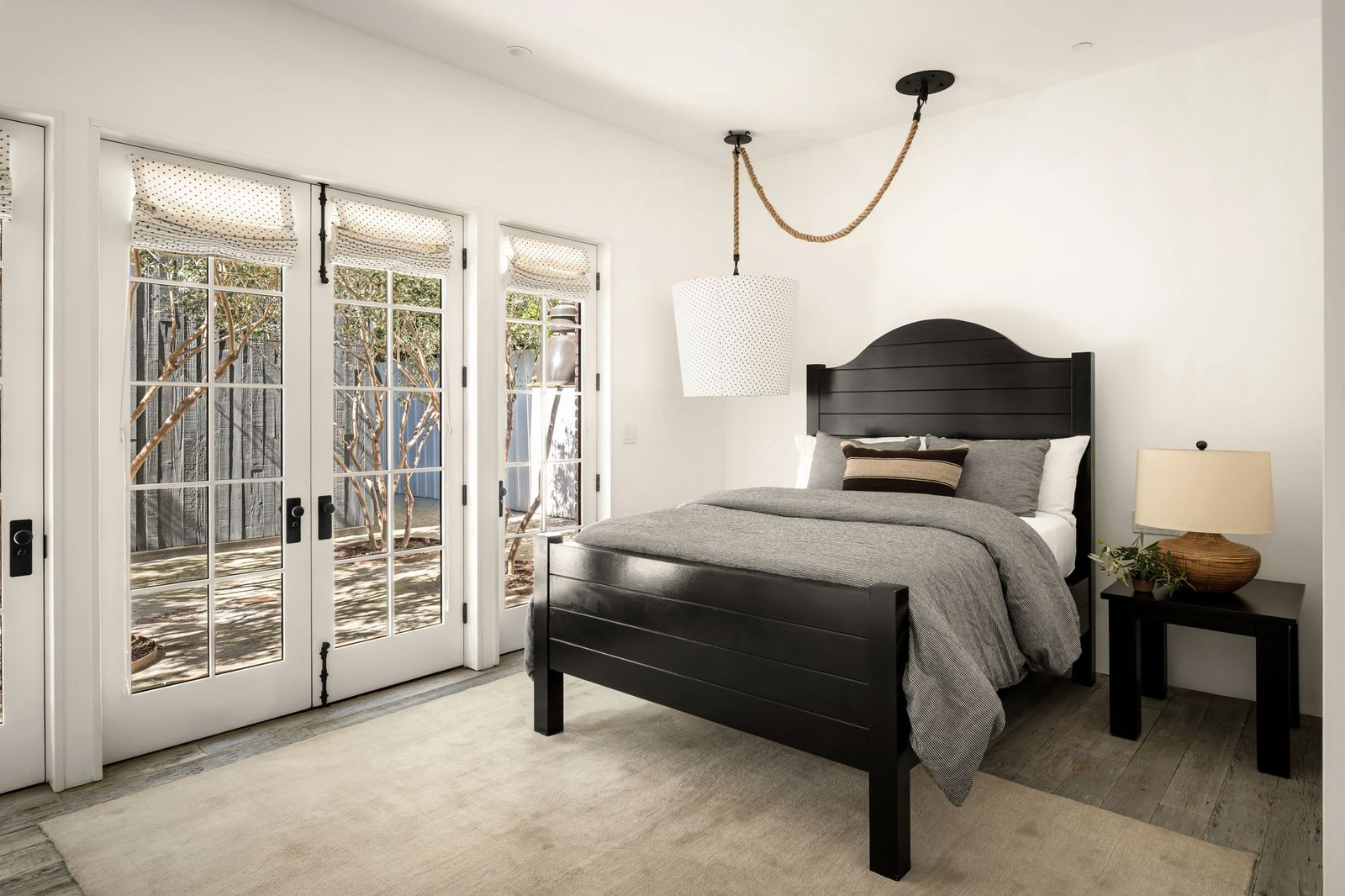 This final bedroom has French doors that open directly onto a private courtyard, creating an indoor-outdoor connection similar to the primary suite.