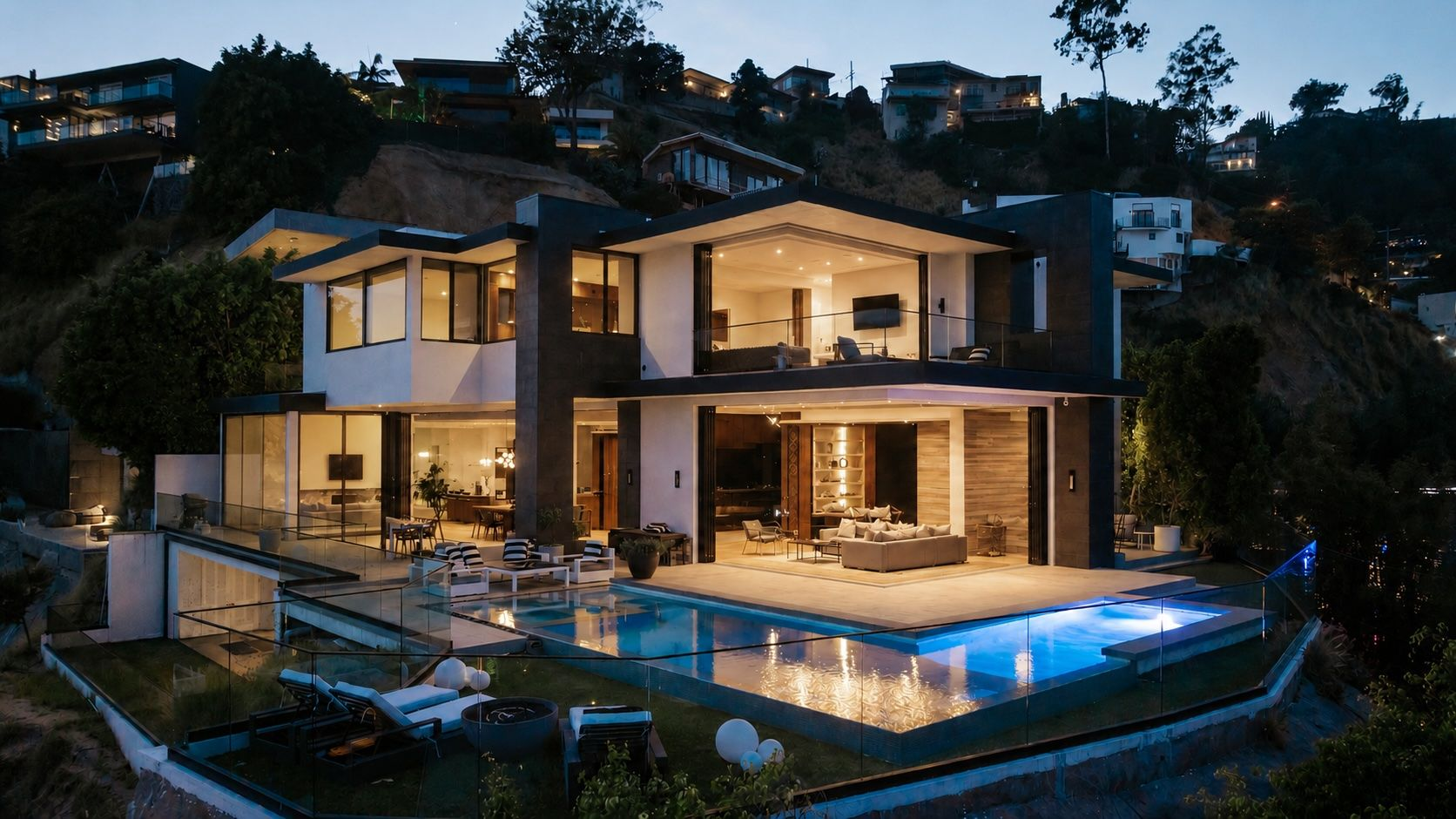 Wrapping around the back of the home, the main terrace can be accessed through multiple glass openings on the main level and extends towards an infinity-edge pool.