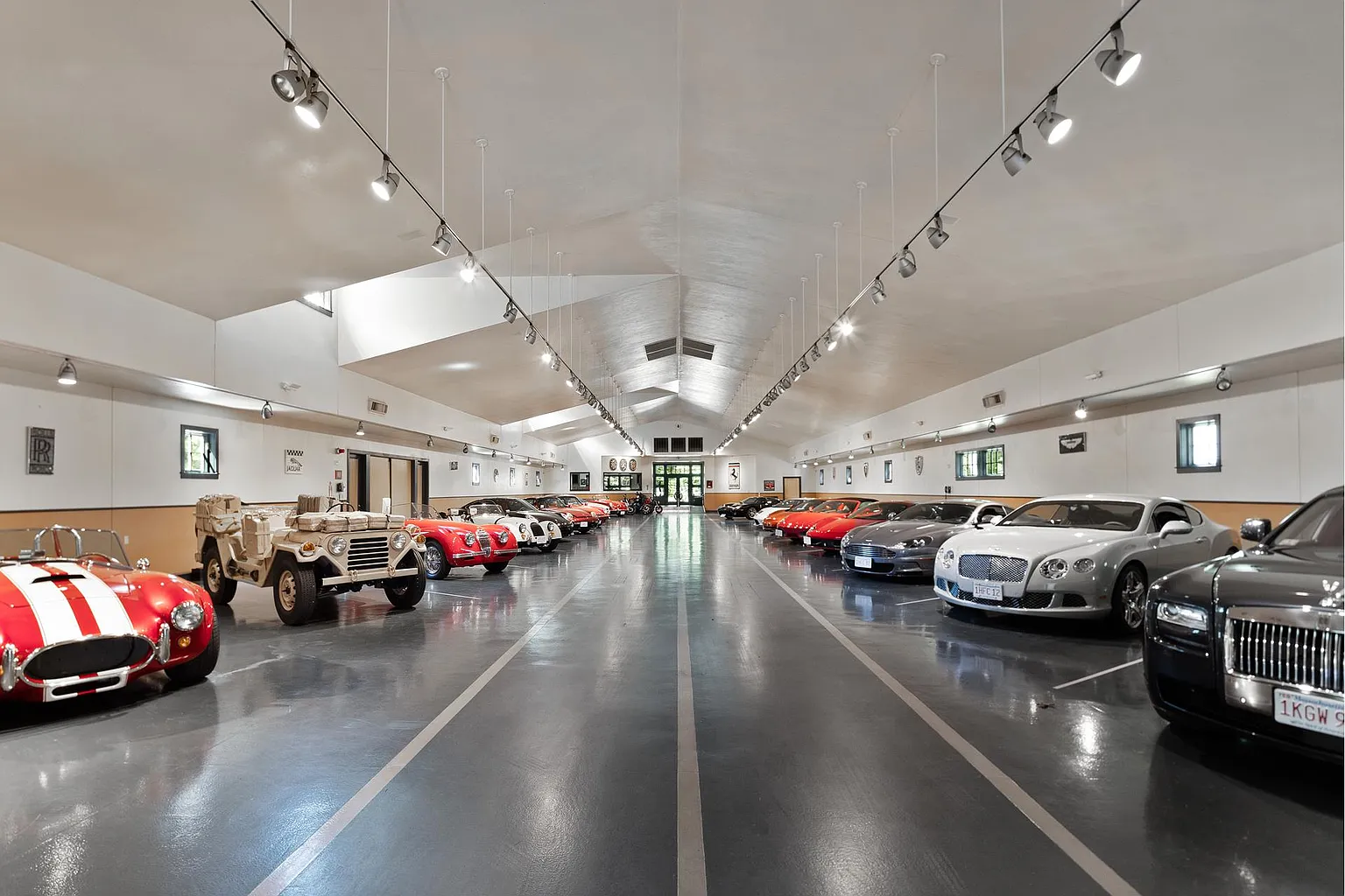 Car barn finished with polished floors, high ceilings, and museum-style lighting.