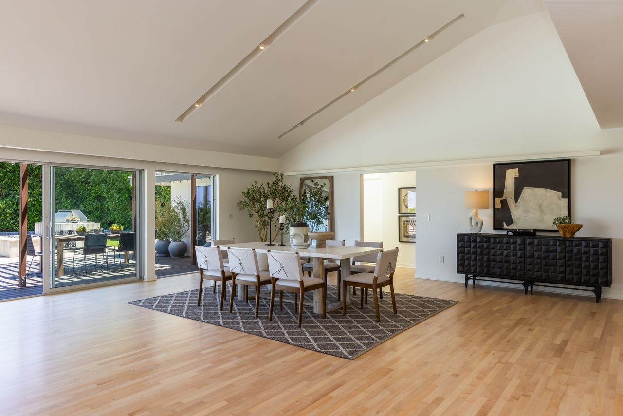 The dining area offers an open setting for entertaining with space for a large table beneath the vaulted ceiling.