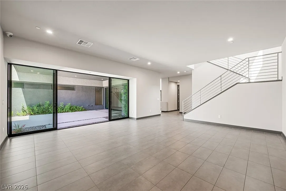 Wide sliding glass doors open directly to an outdoor patio, bringing in natural light.