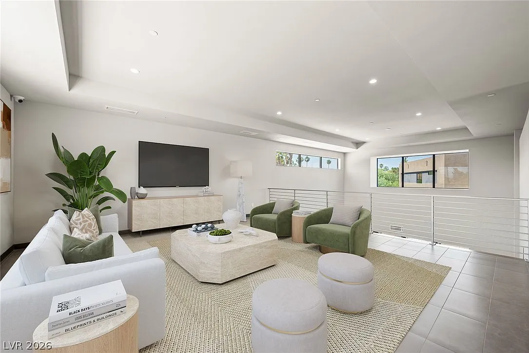 At the top of the staircase, the home opens into a spacious loft that overlooks the double-height great room below.