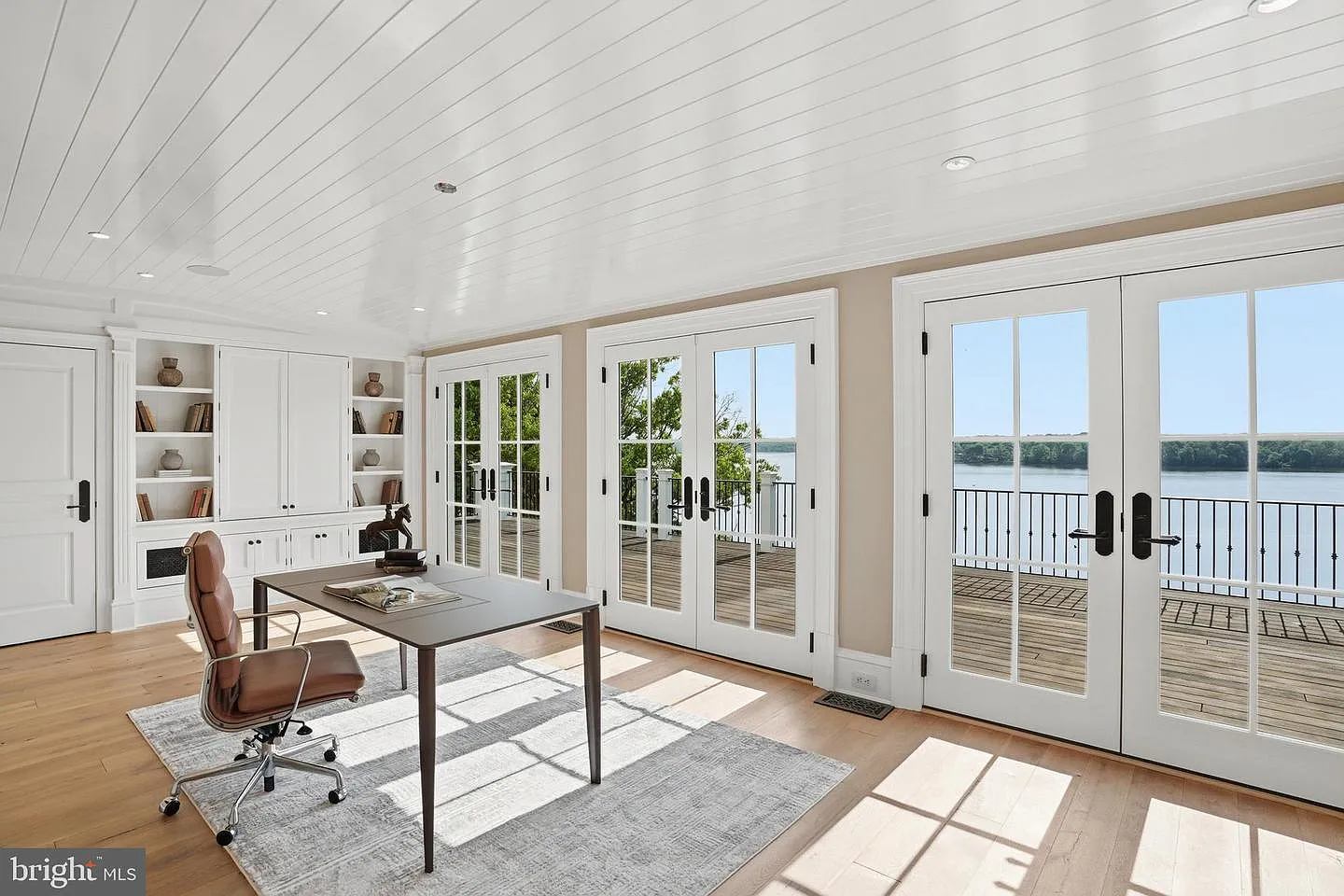 For those working from home, a dedicated office overlooks the river through a wall of French doors and windows. 