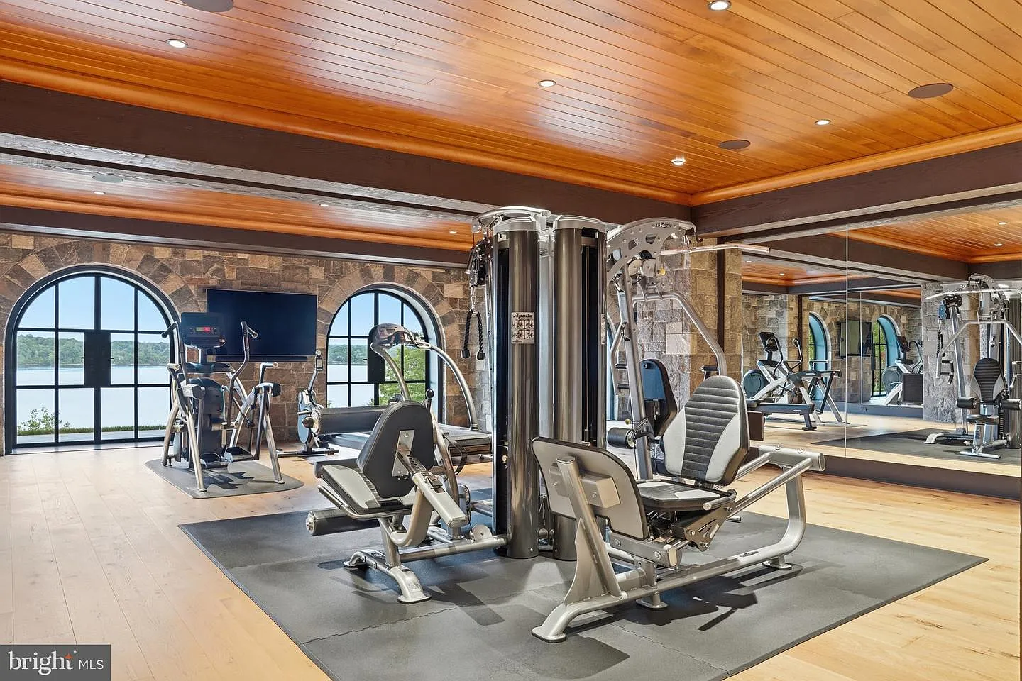 The mansion's wellness facilities start with a fitness center that features a full range of strength and cardio equipment within a spacious room lined with mirrors.