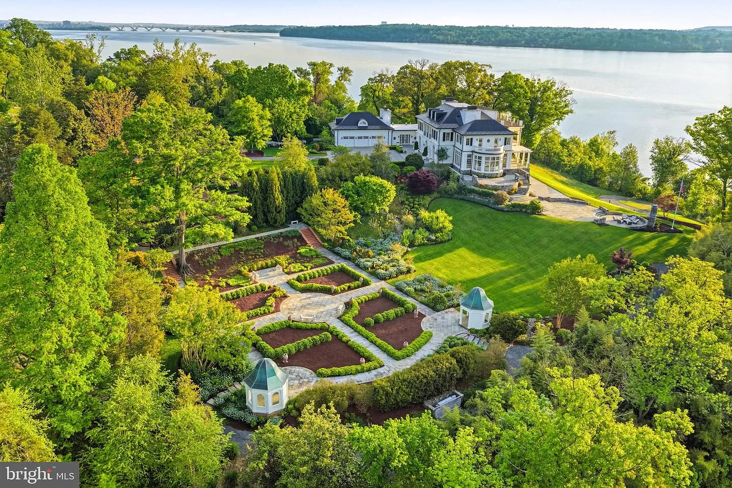 Laid out in a formal geometric pattern, the garden is organized around stone walkways, manicured hedges, and symmetrical plant beds.