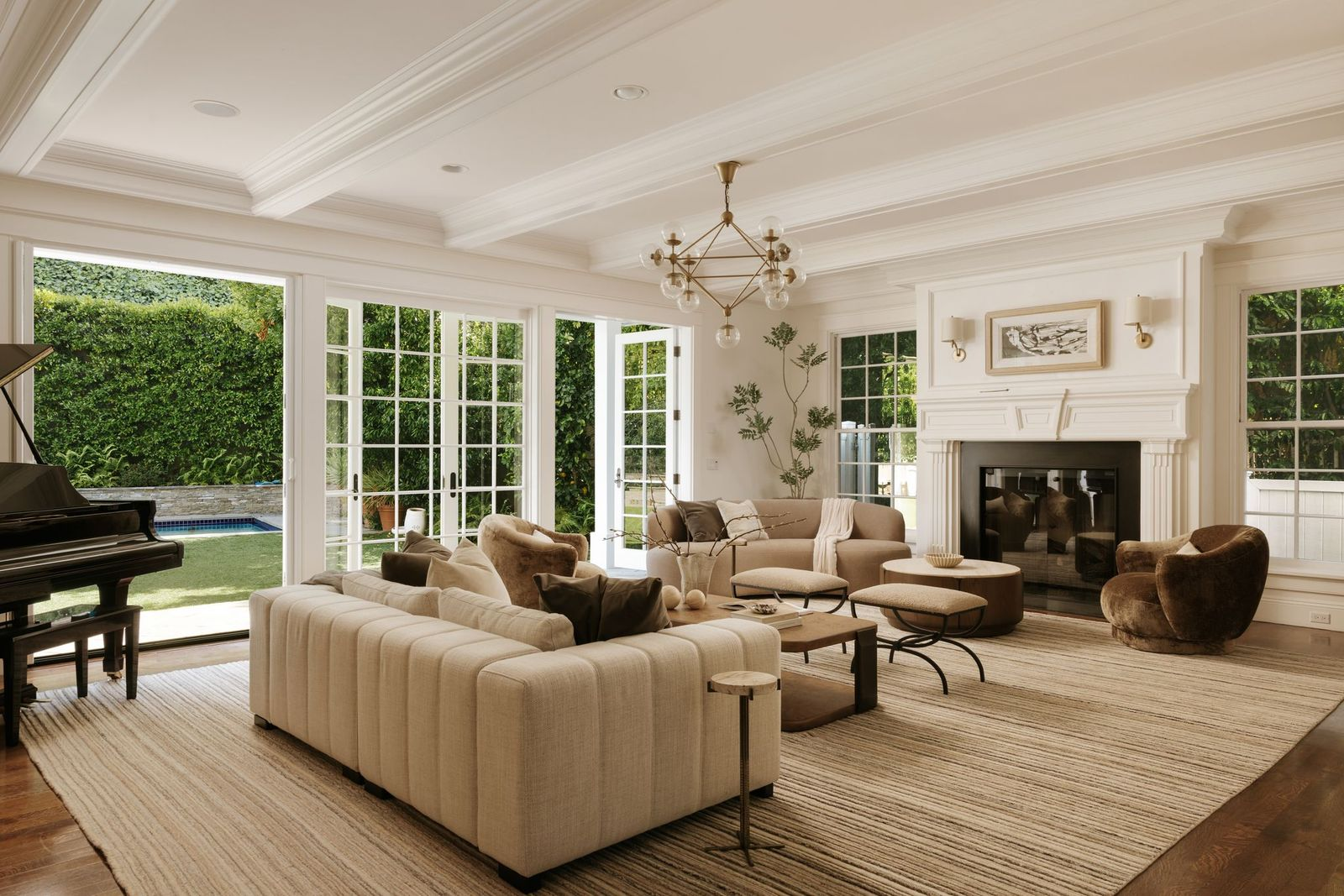Straight down the hall from the foyer, the living room serves as one of the home's primary gathering spaces beside a traditional fireplace and with direct backyard access.