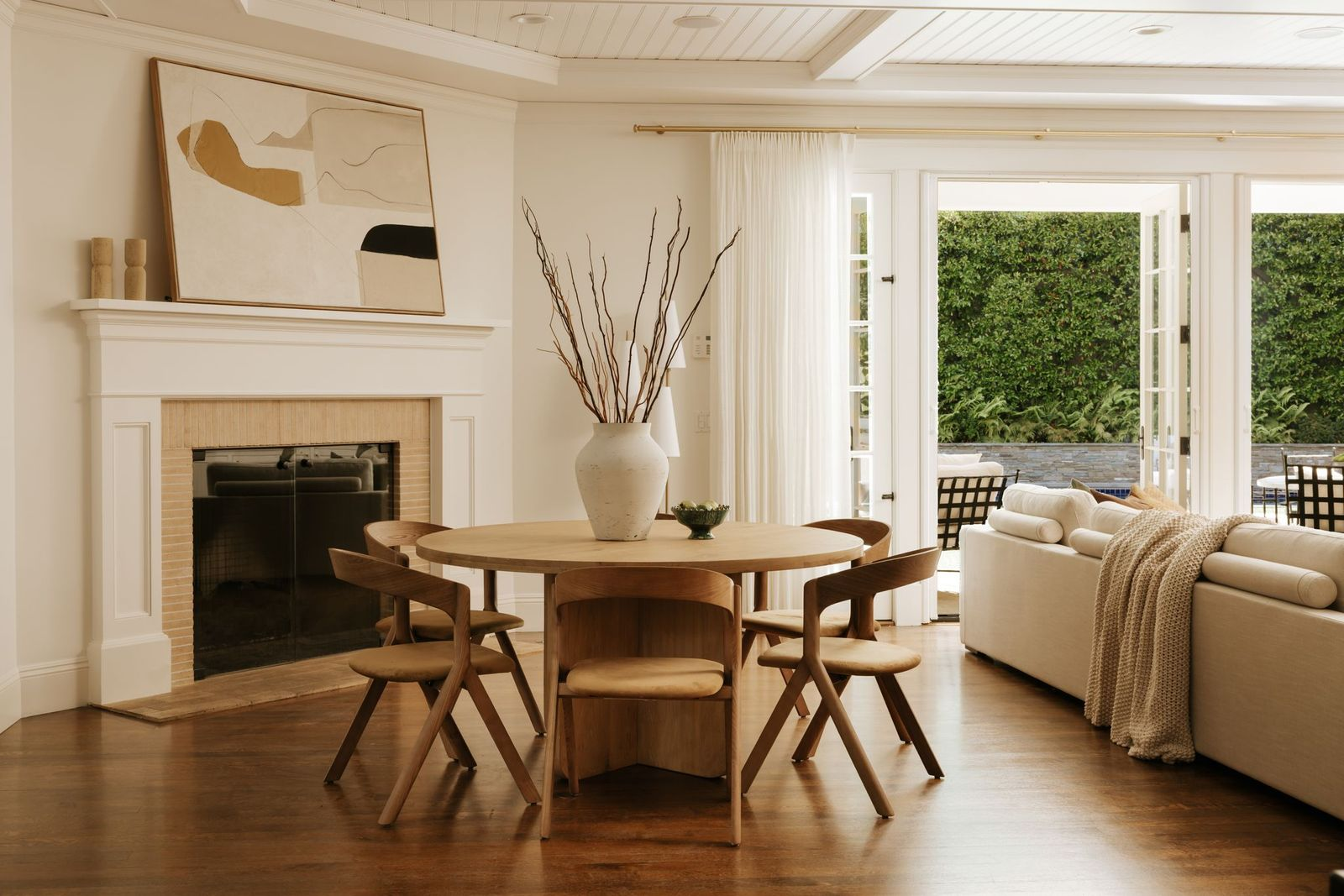 Integrated into the room is a casual dining area positioned beside a second fireplace and consisting of a round wood table with matching chairs.
