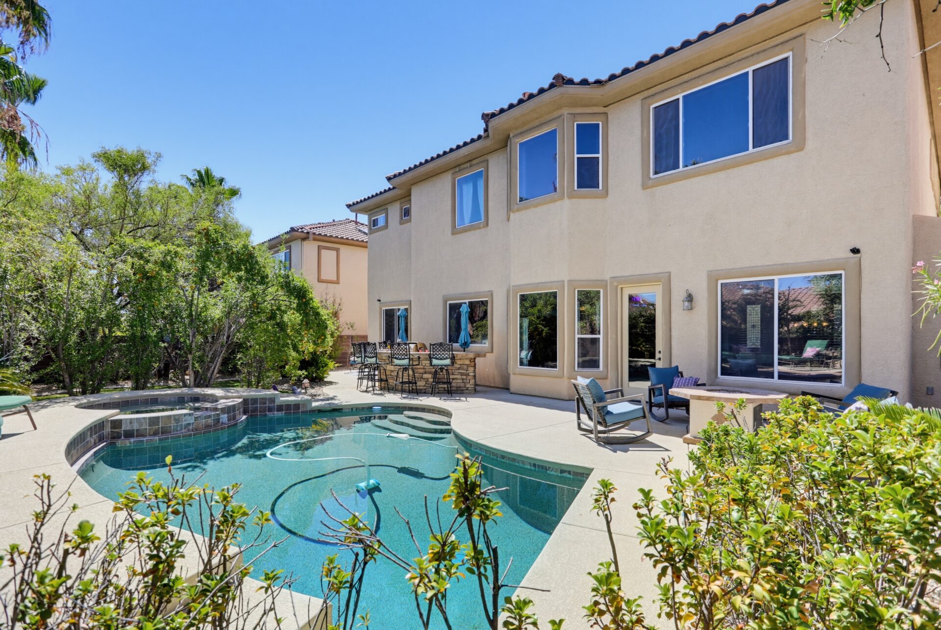 The backyard is centered around a heated swimming pool and raised spa finished with new PebbleTec.