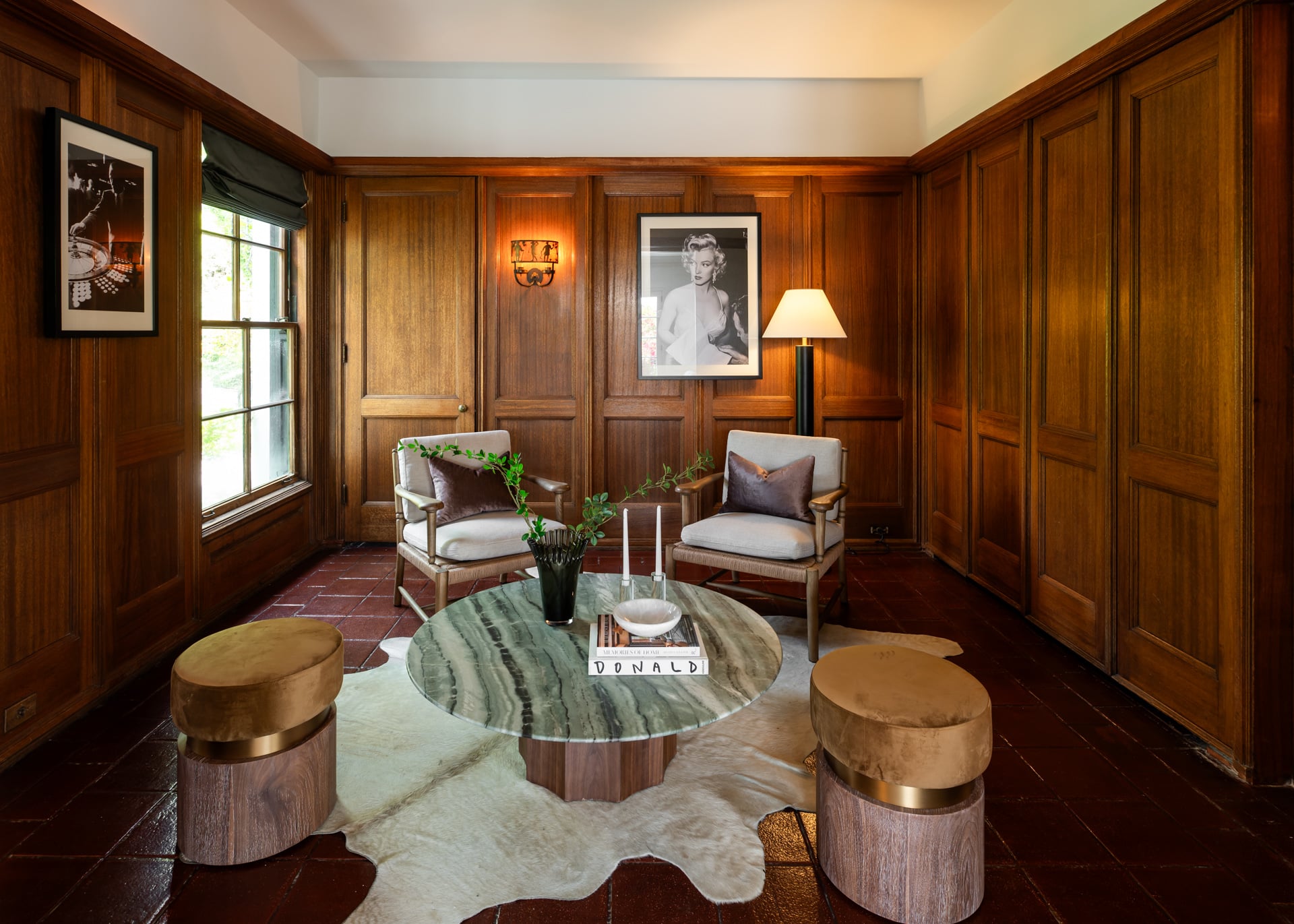 The bar lounge offers a more intimate space for gathering, with a comfortable seating area arranged around a stone-topped coffee table. 